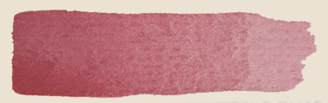 A horizontal swatch of pink watercolor paint on textured paper.