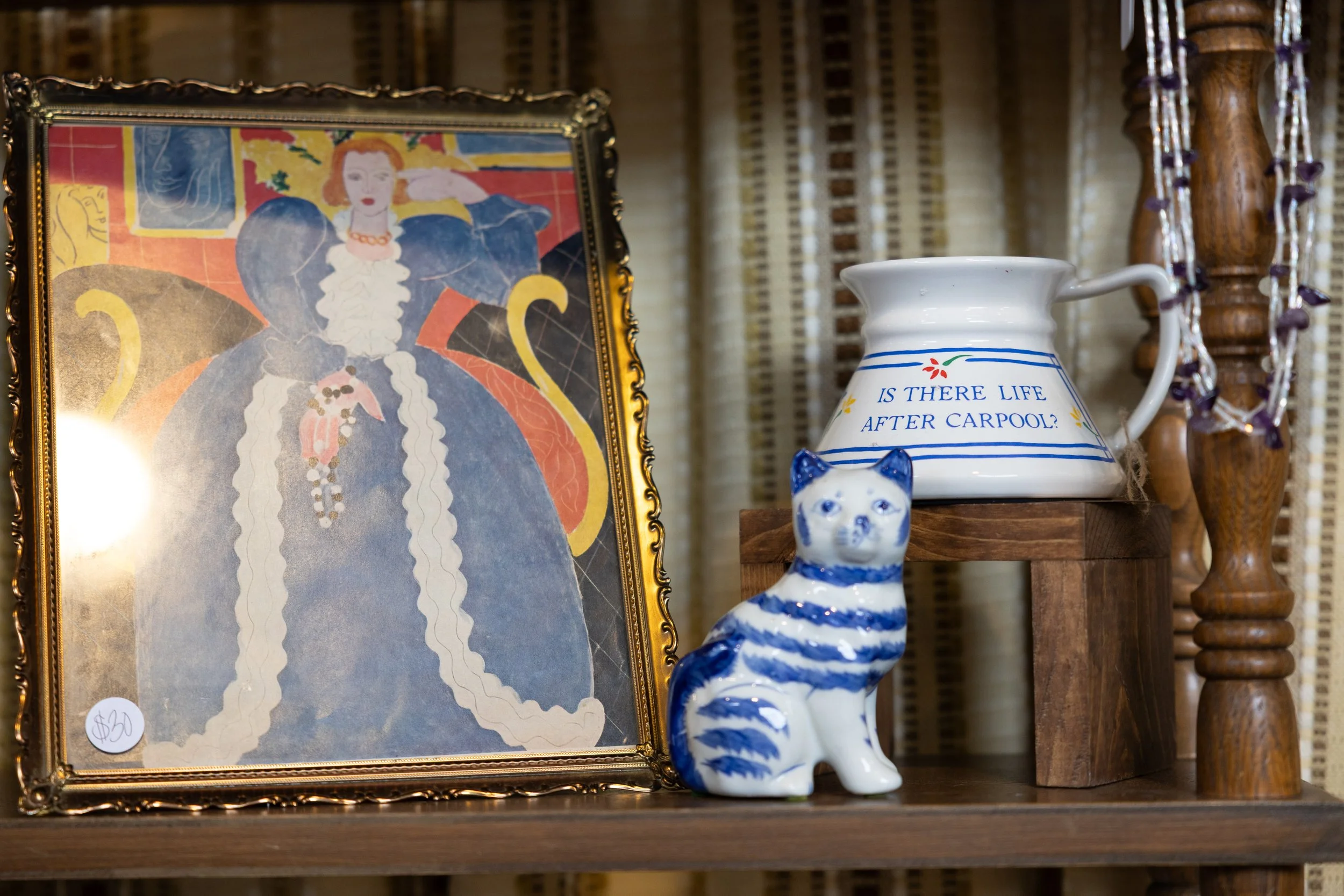 Display of various vintage wares on a shelf.
