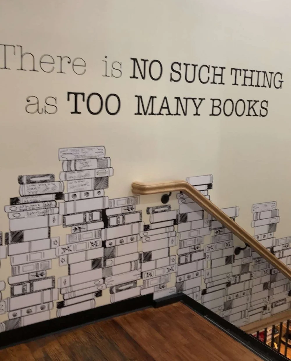 Writing on a wall at the Strand Bookstore that reads There's No Such Thing As Too Many Books