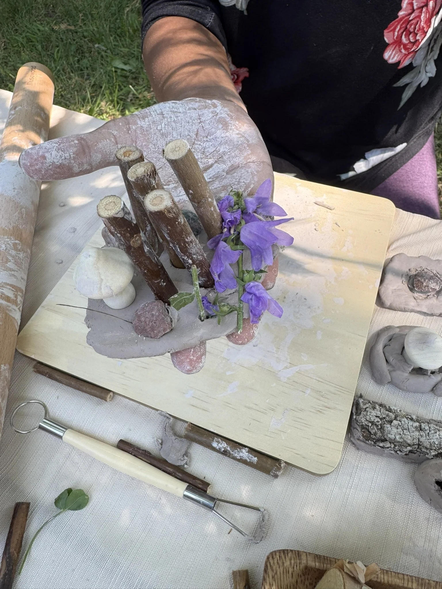 A little nature city! Mushroom, rocks, sticks, wildflowers, some water and clay. Really doesn't take much to have fun!