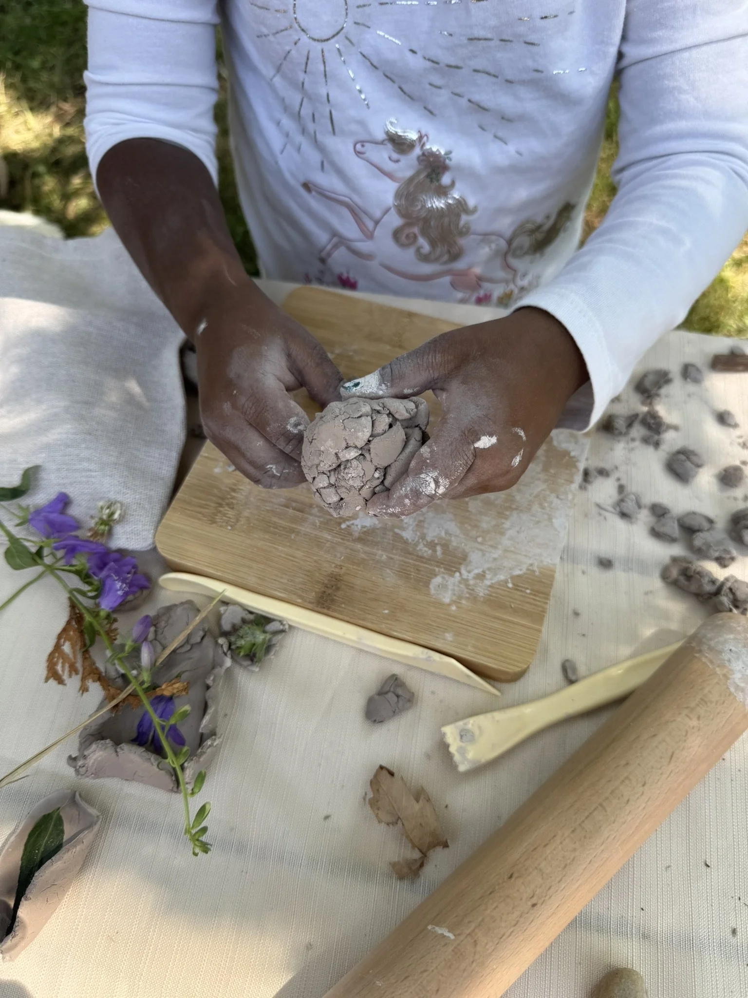 This little girl put her fine motor skills to work as she crushed her creation to make way for a new idea.
