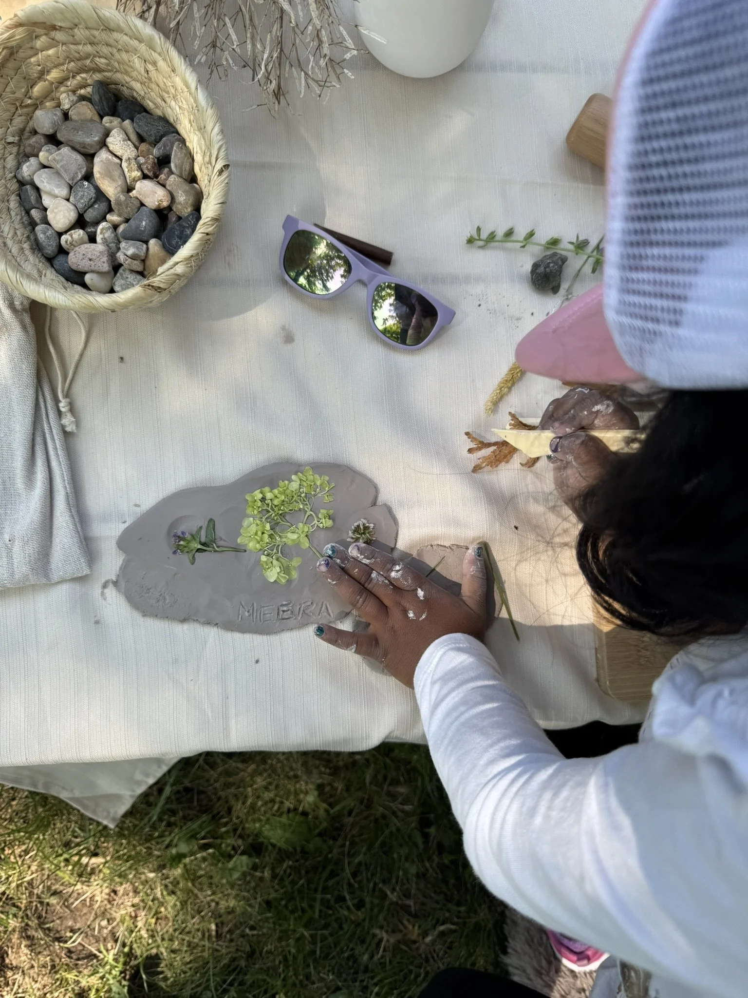 Children used natural items to imprint patterns into the clay—some chose to keep and preserve the objects within their creations.