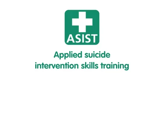 Scenic landscape of a lake surrounded by rolling green hills and tall mountain ranges under a cloudy sky.