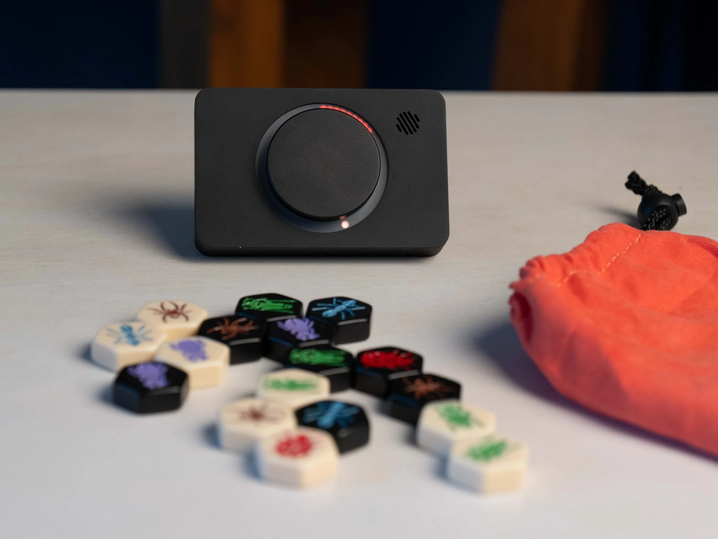Pomodoro timer on light coloured desk with board game