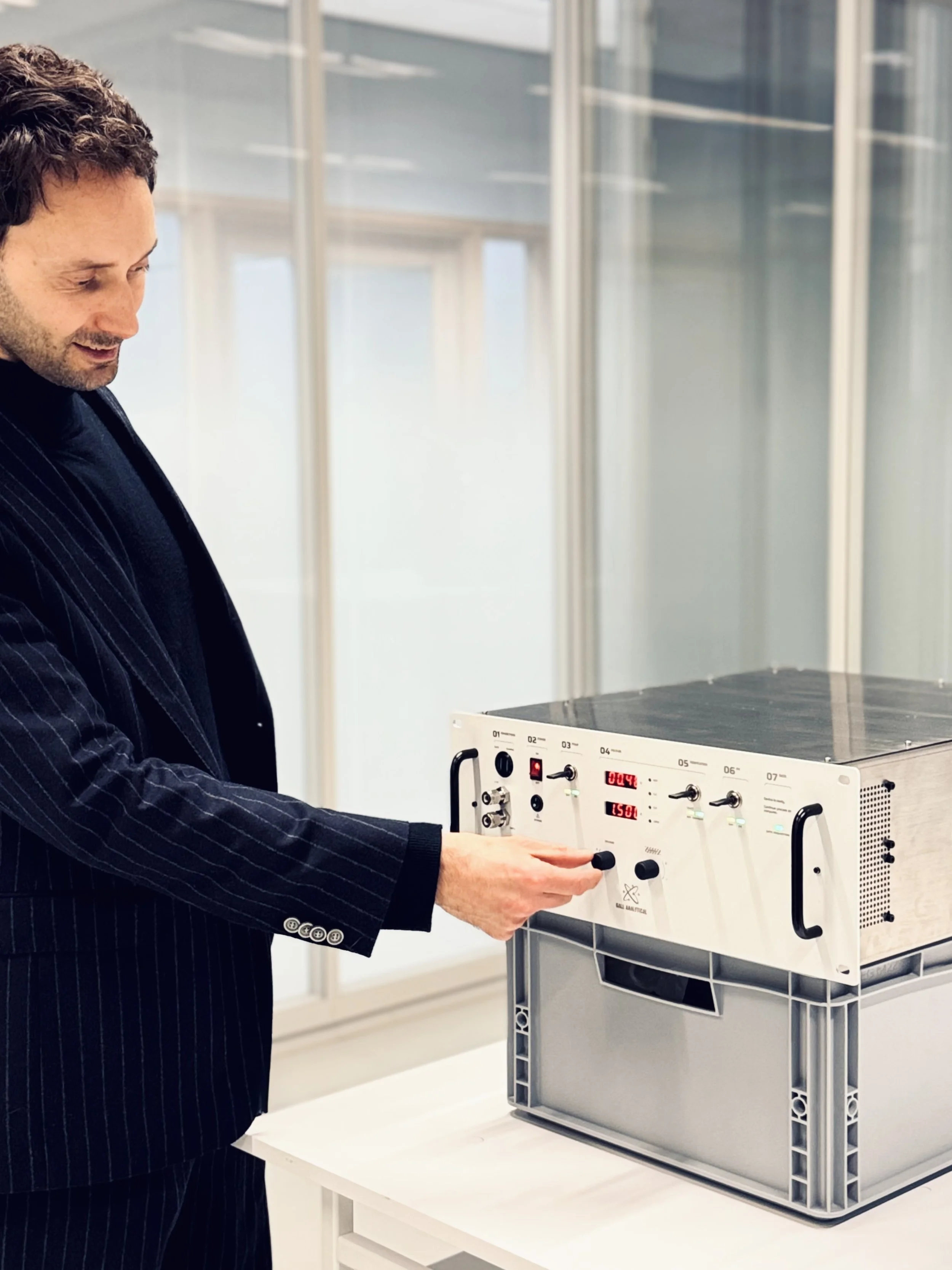 Picture of the client receiving the new rack mount scientific unit and trying out the controls for the first time