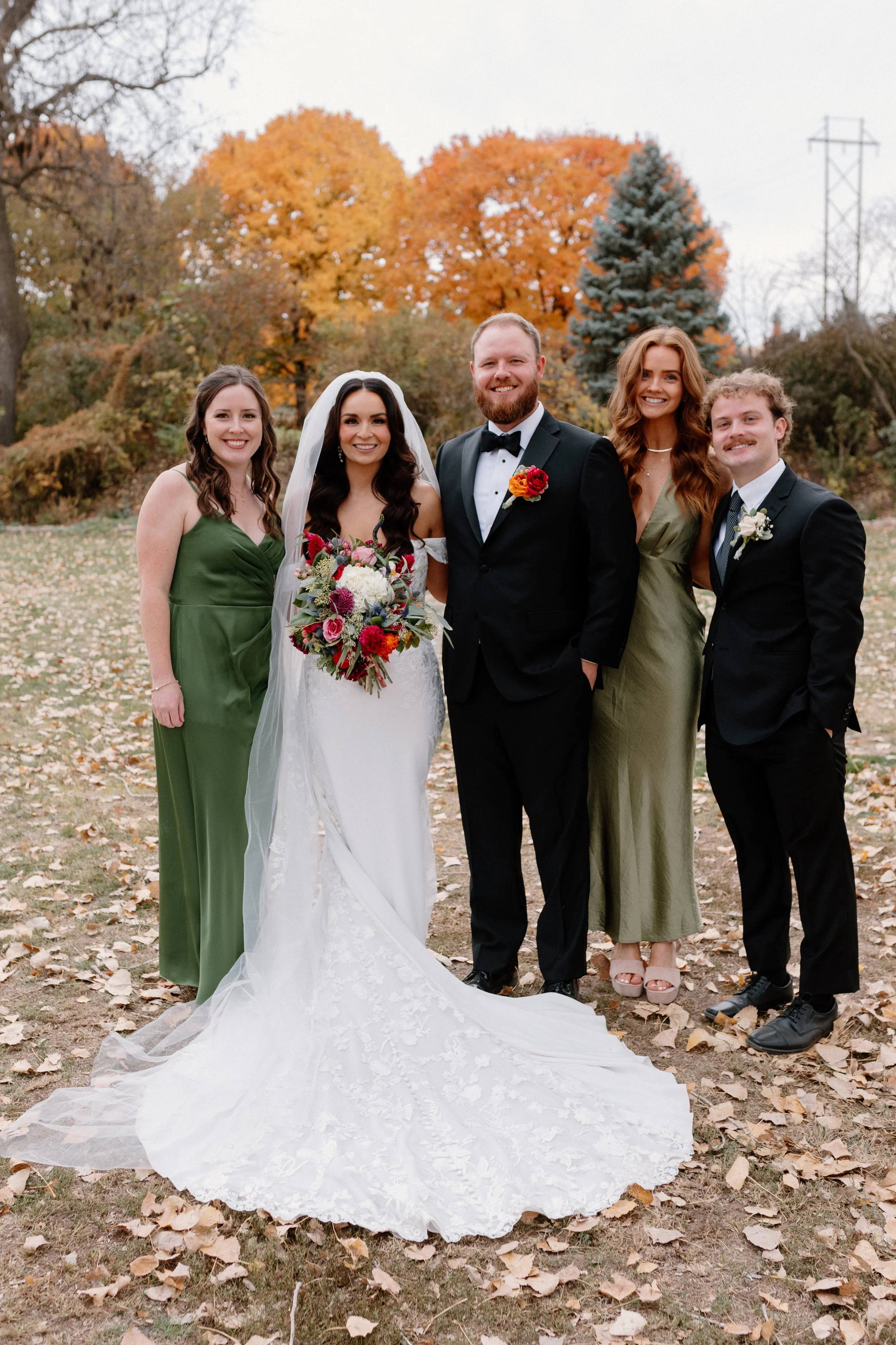 Bride in a white wedding dress holding a colorful bouquet. Louisville Nebraska Wedding Photographer