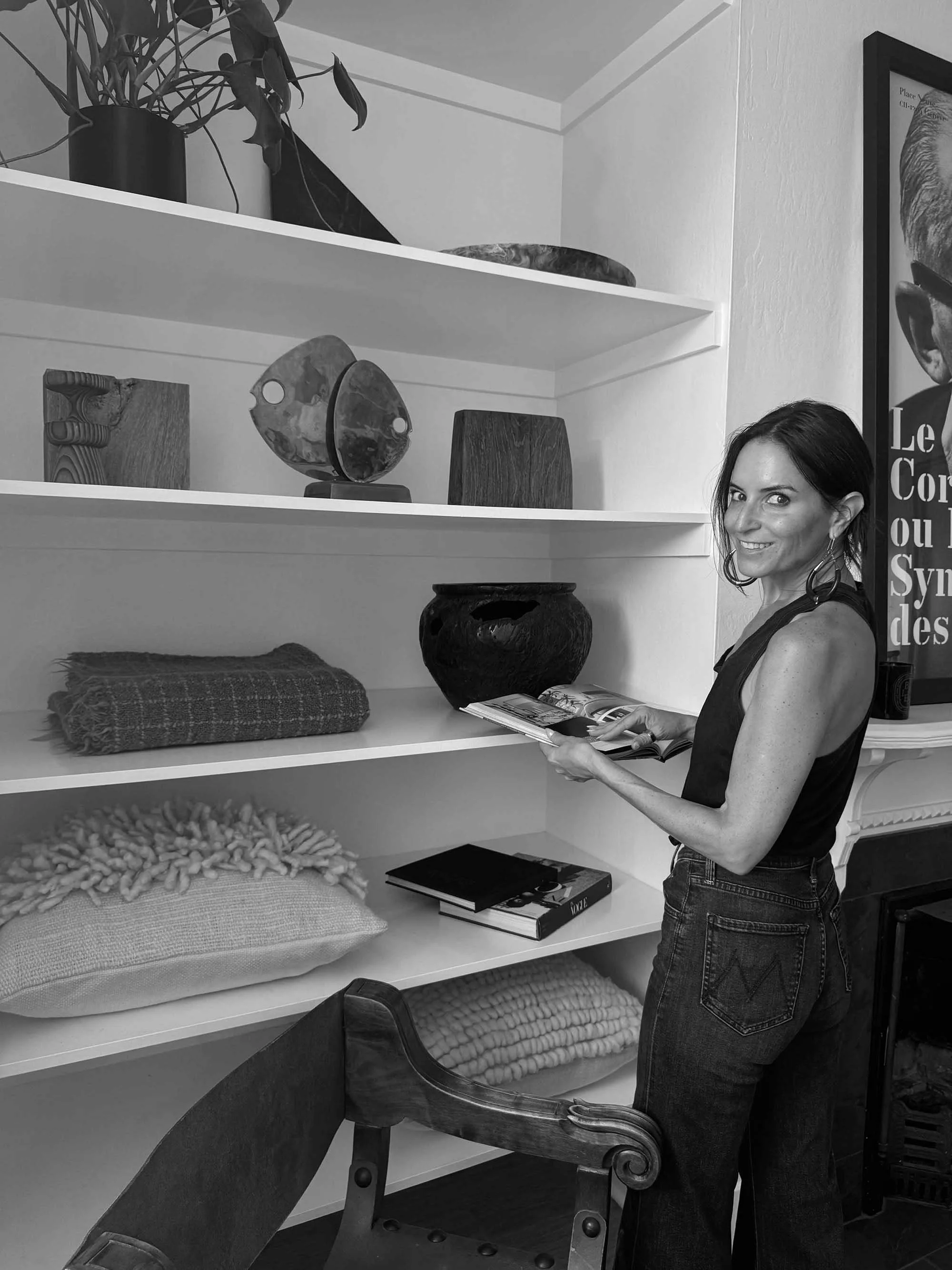 San Francisco interior stylist Nicole Johnson arranging vintage decor and sculptural pieces during an editorial design shoot