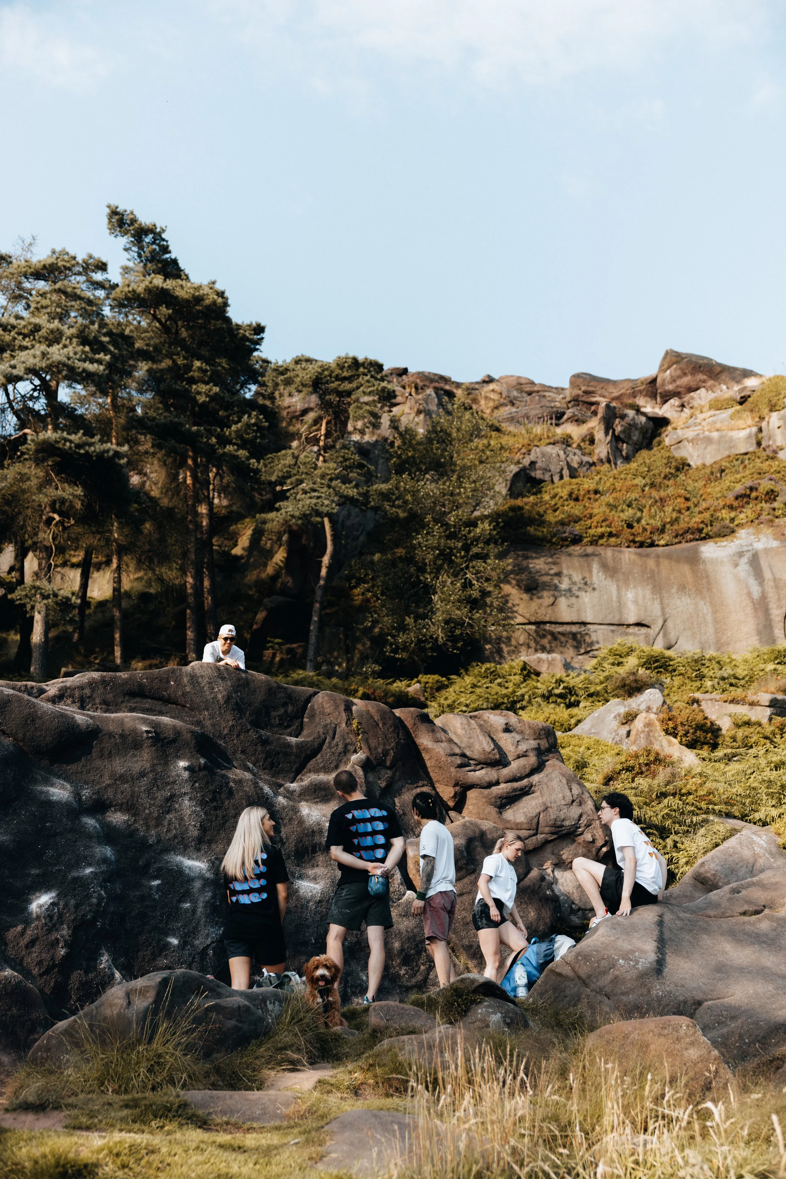 Group of climbers gathered around outdoor boulders