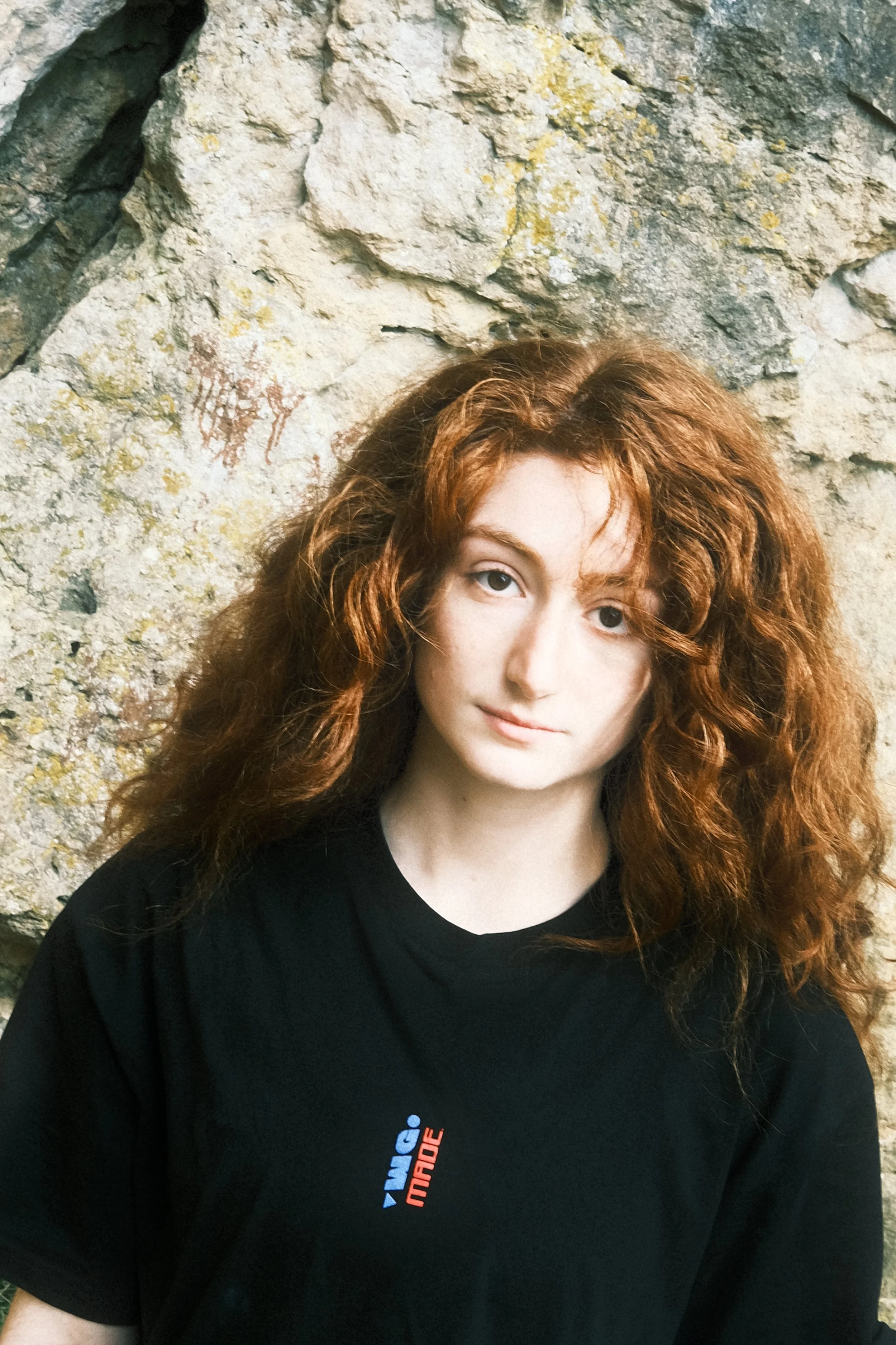 Woman wearing Contact Point tee shirt in outdoor bouldering area