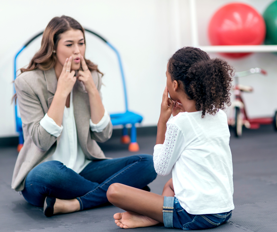 Speech therapist and client sit on the floor practicing speech techniques