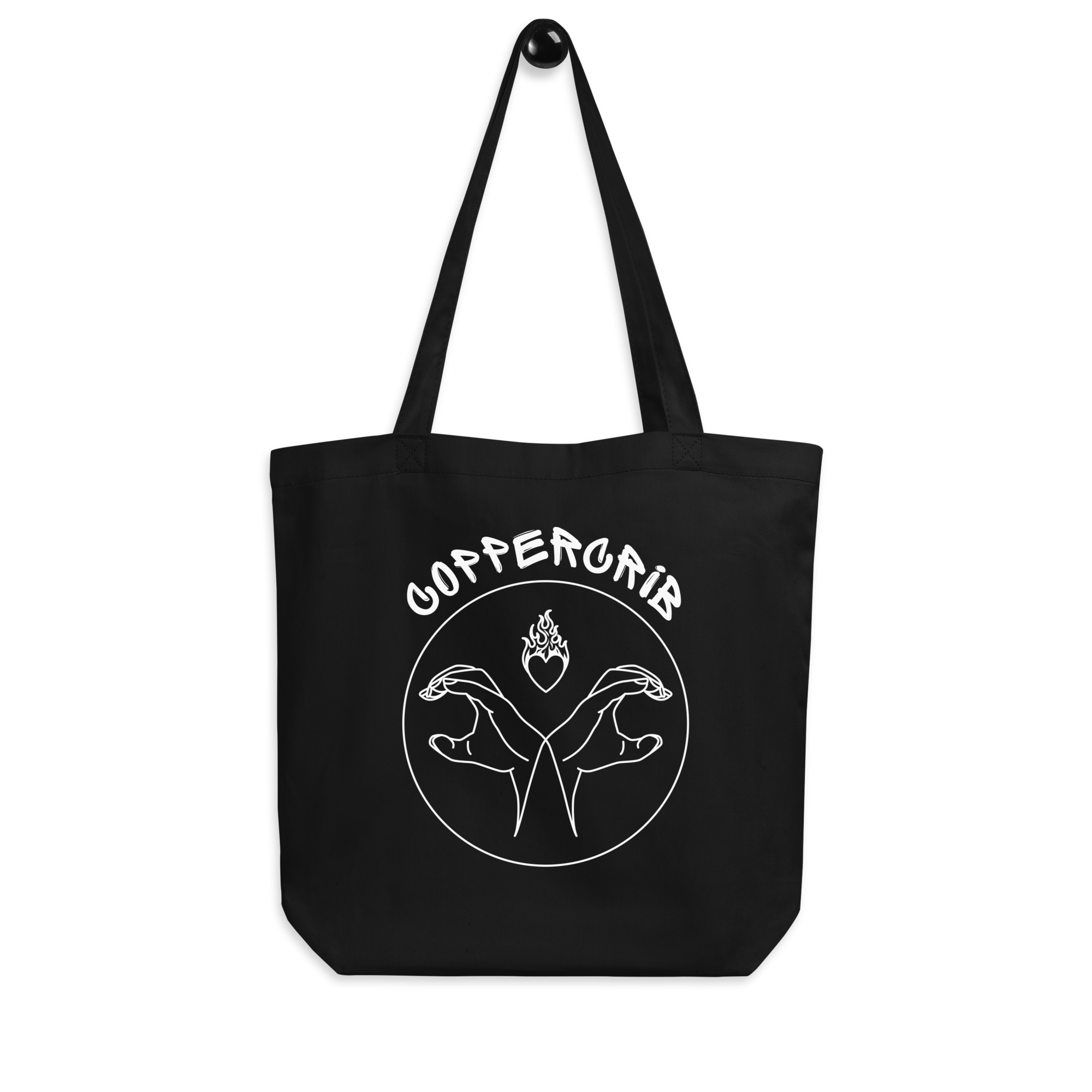 Un sac en toile noir avec un design blanc représentant deux mains stylisées formant un cœur avec une flamme au centre. La légende « coppercrib» est écrite en haut en lettres arrondies.
