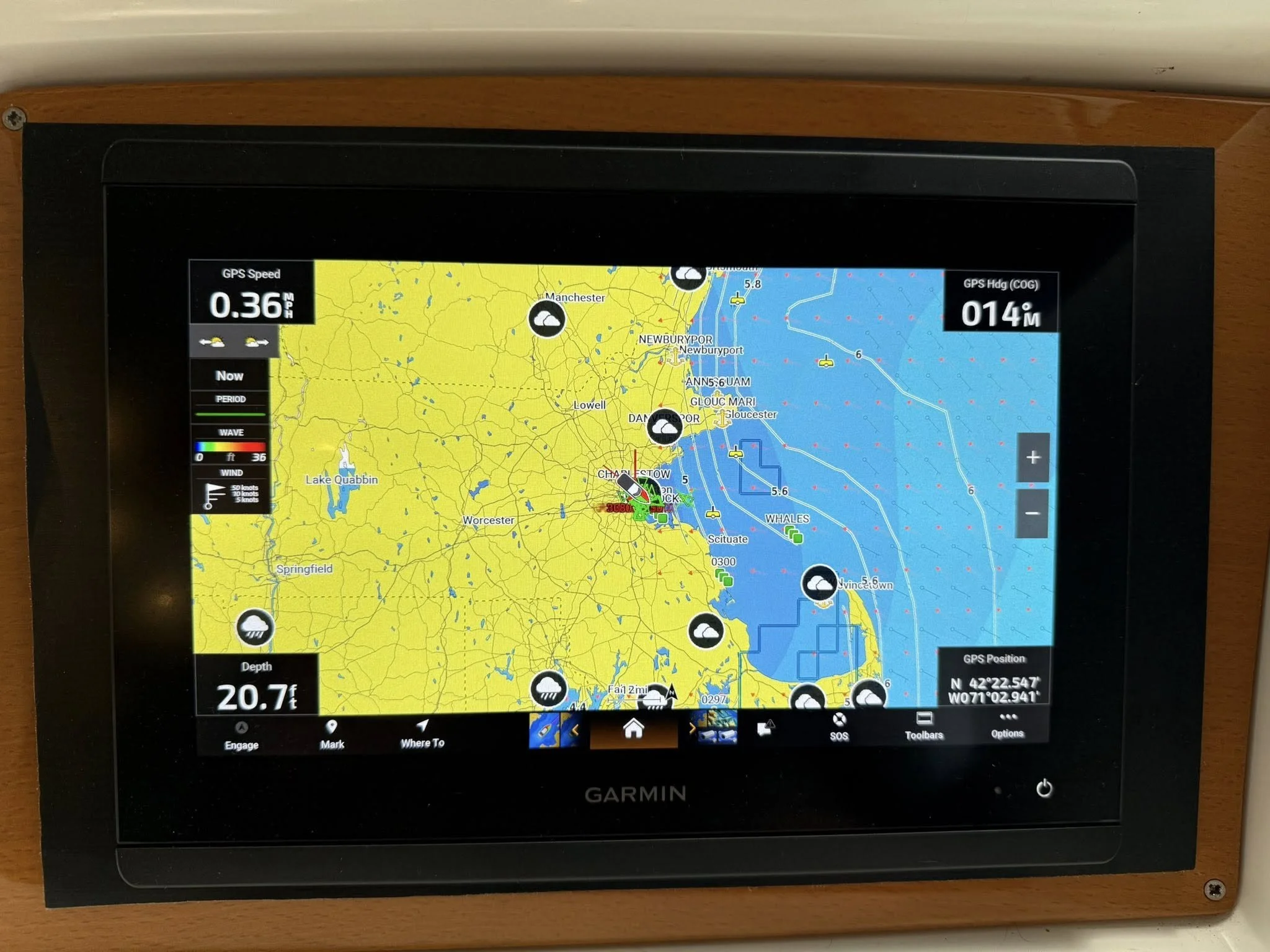 Garmin marine navigation chart displaying coastal weather and water conditions near Gloucester, Massachusetts, showing wave height, wind speed, depth, and locations of weather icons and vessels.
