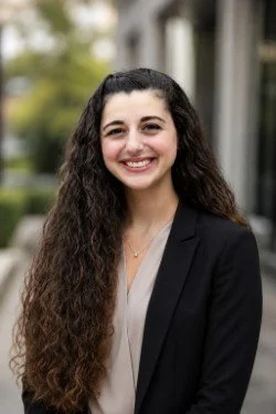an image of Dominique Toscano smiling at the camera