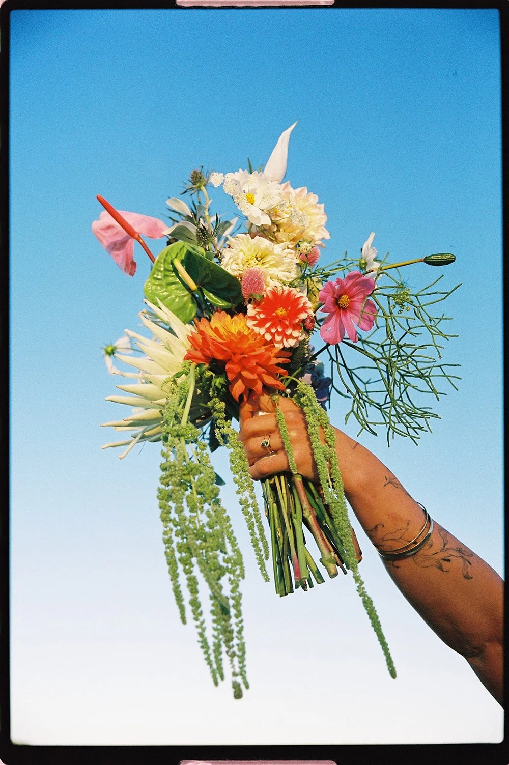 wedding bouquet and vintage engagement ring photographed on 35mm film at the beach