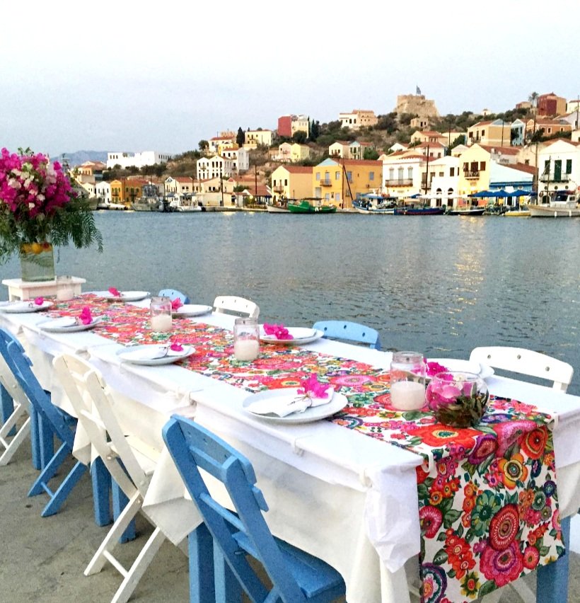 A table set for a sunset dinner along the picturesque harbor of Kastellorizo (Megisti, Meis), where Greek and Turkish culinary influences come together.