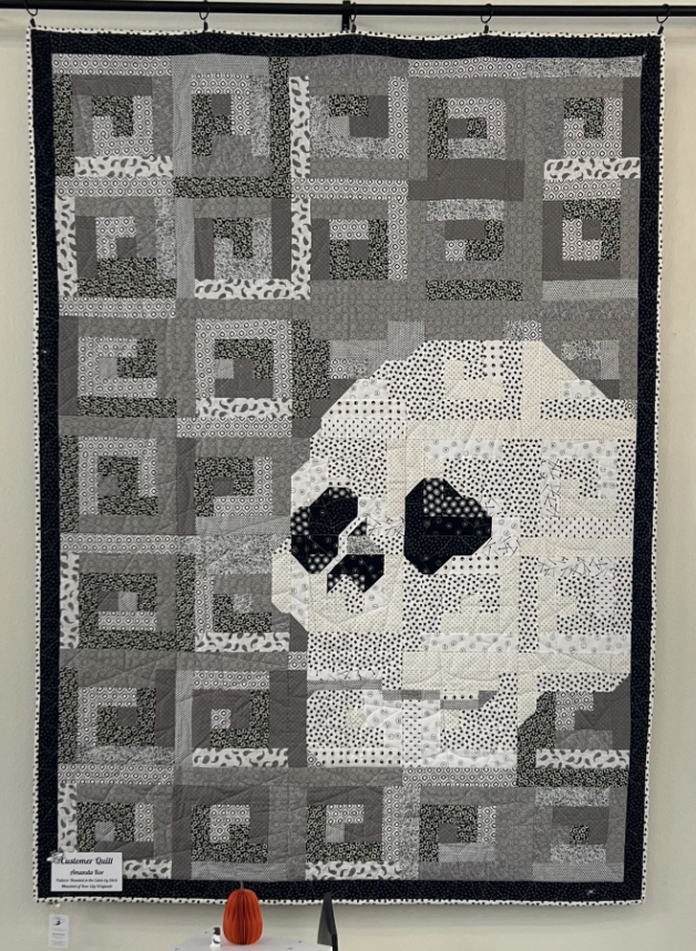Monochromatic interpretation of Chris Marchini's Haunting in the Cabin (Rose City Originals). What sets this pattern apart is the skull is integrated INTO the log cabin design and not an appliqué!