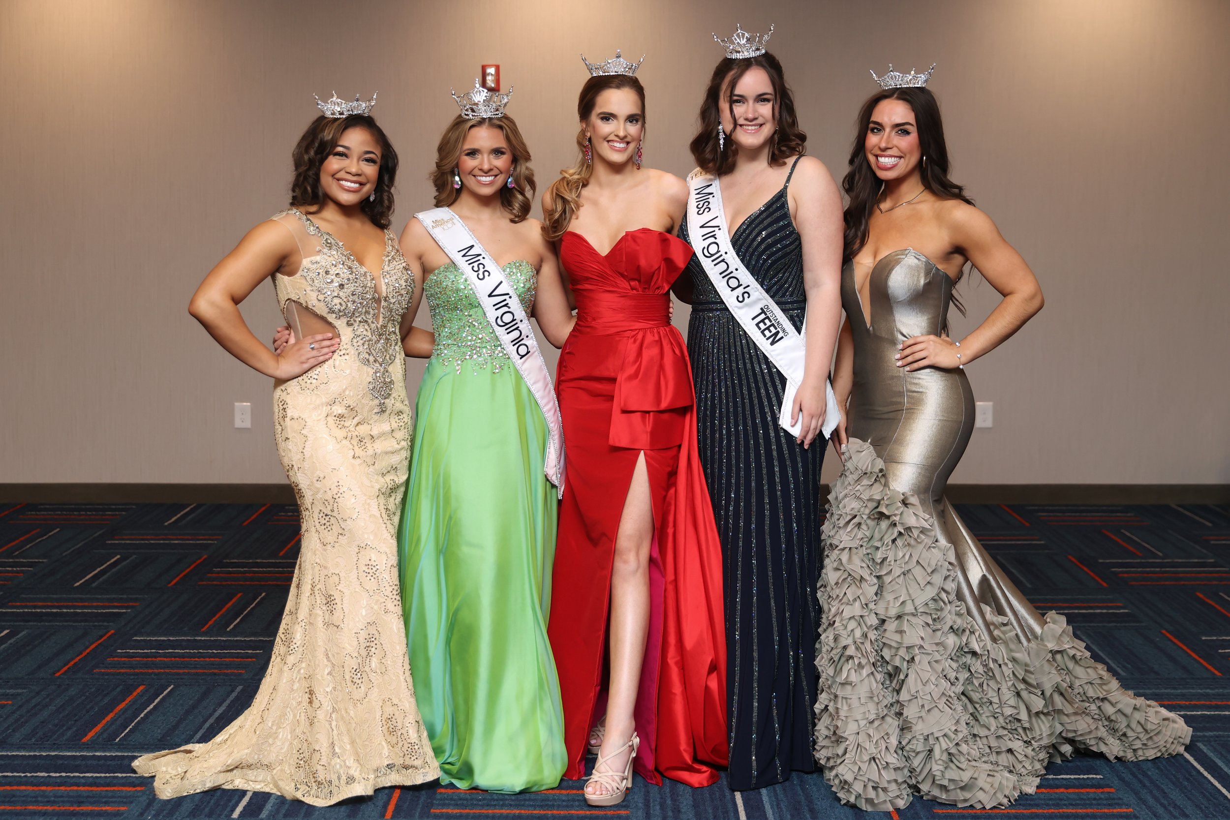 Group of five women wearing evening gowns and tiaras, two with sashes that read 'Miss Virginia' and 'Miss Virginia's Teen', standing in a line and smiling at the camera.