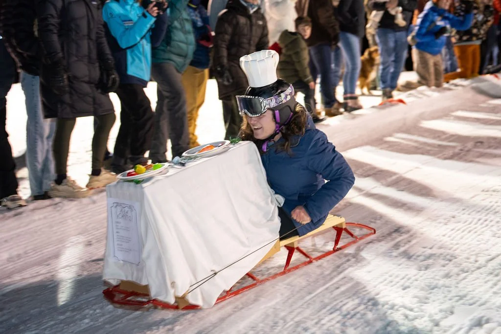 a sled with a dining table attached sliding on snow