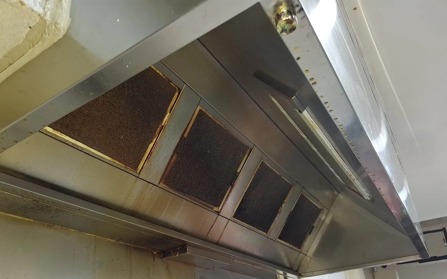 Kitchen exhaust hood and filters covered with grease and oil