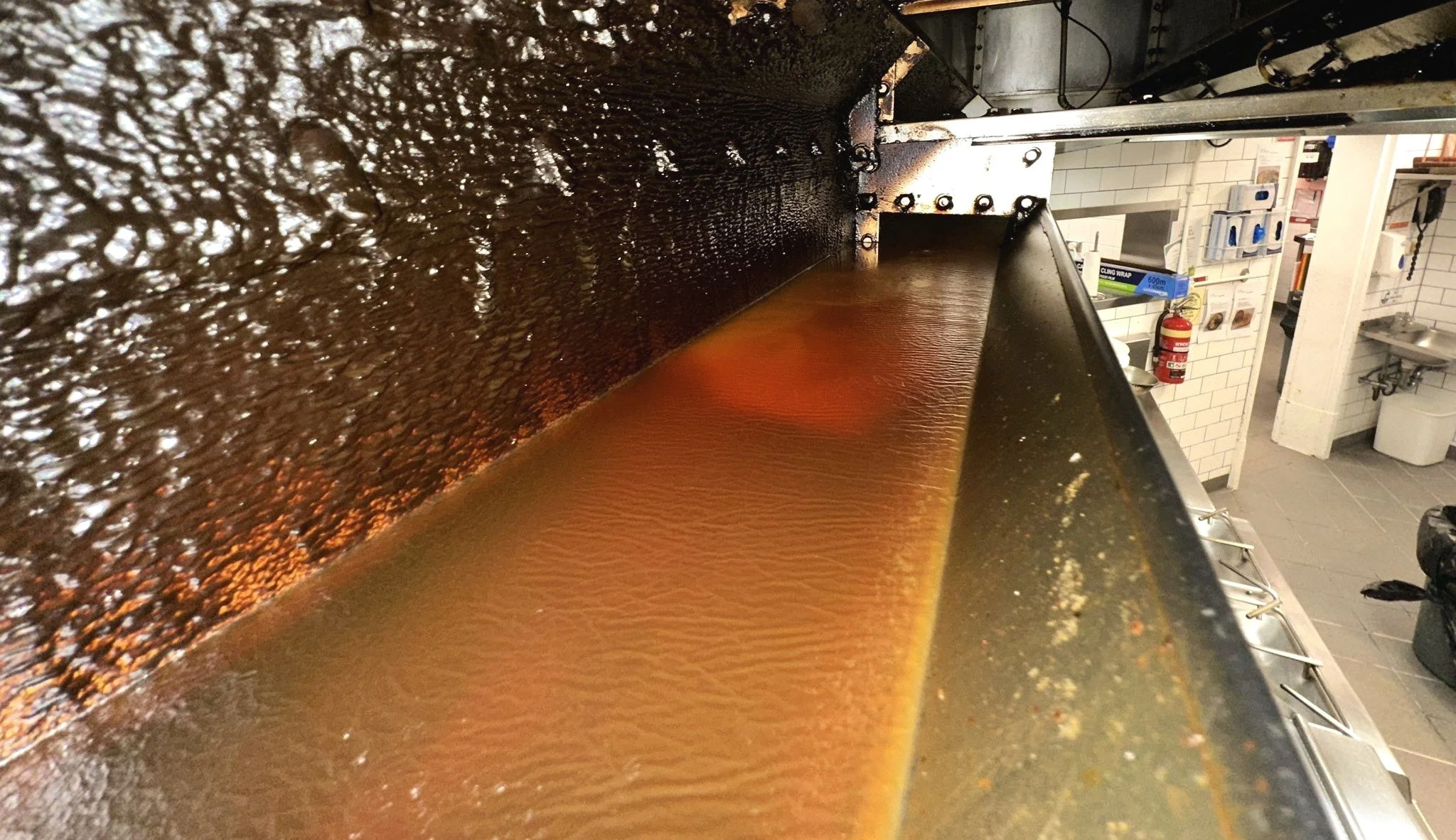 Grease buildup inside a commercial kitchen exhaust hood