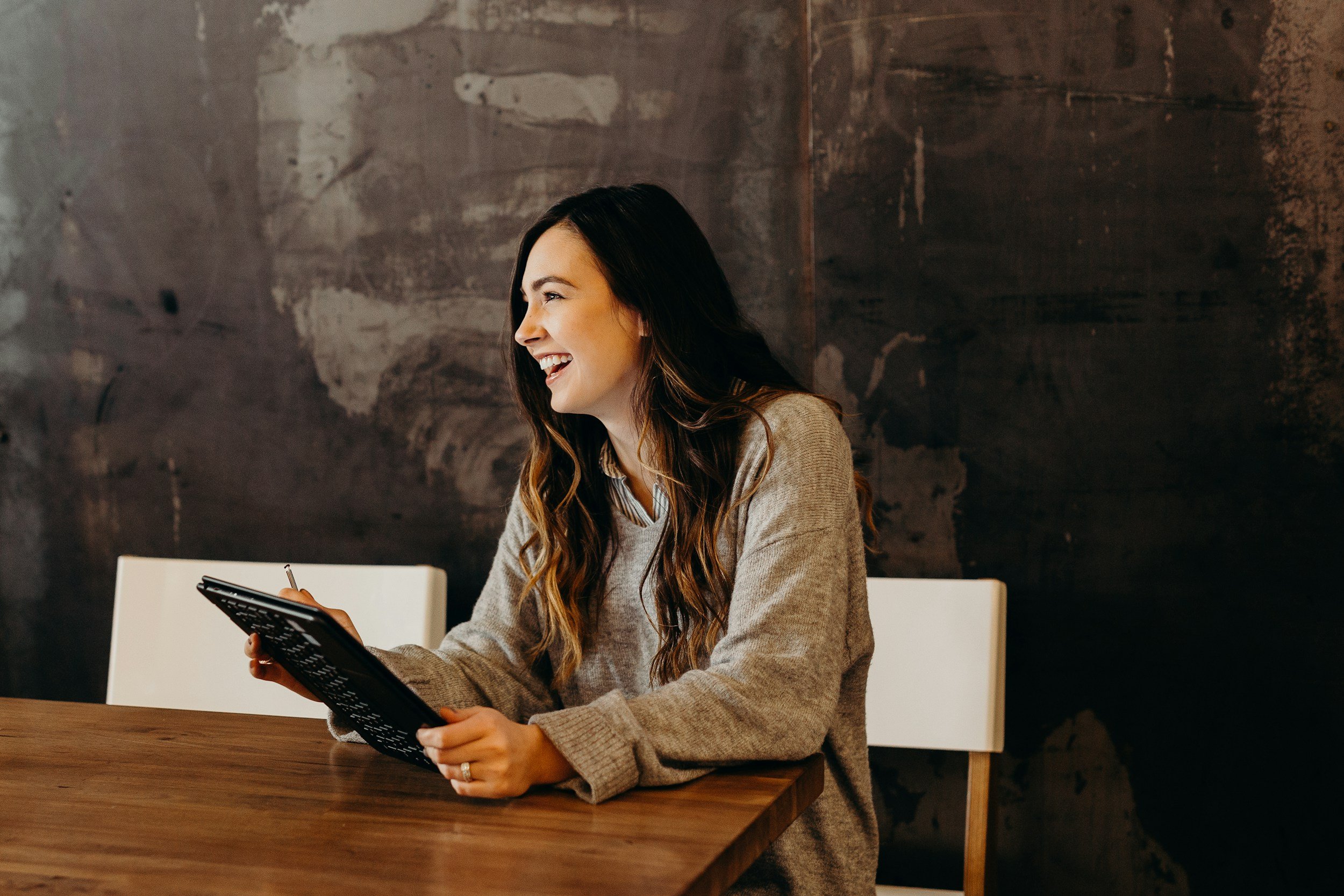 Female holding notebook smiling