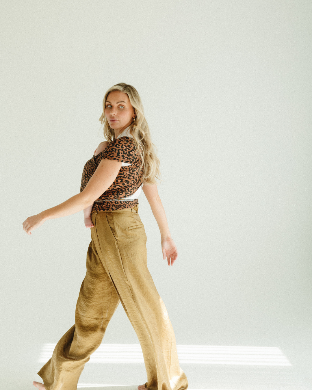 white wall cyclorama photo of mum walking across the shot 