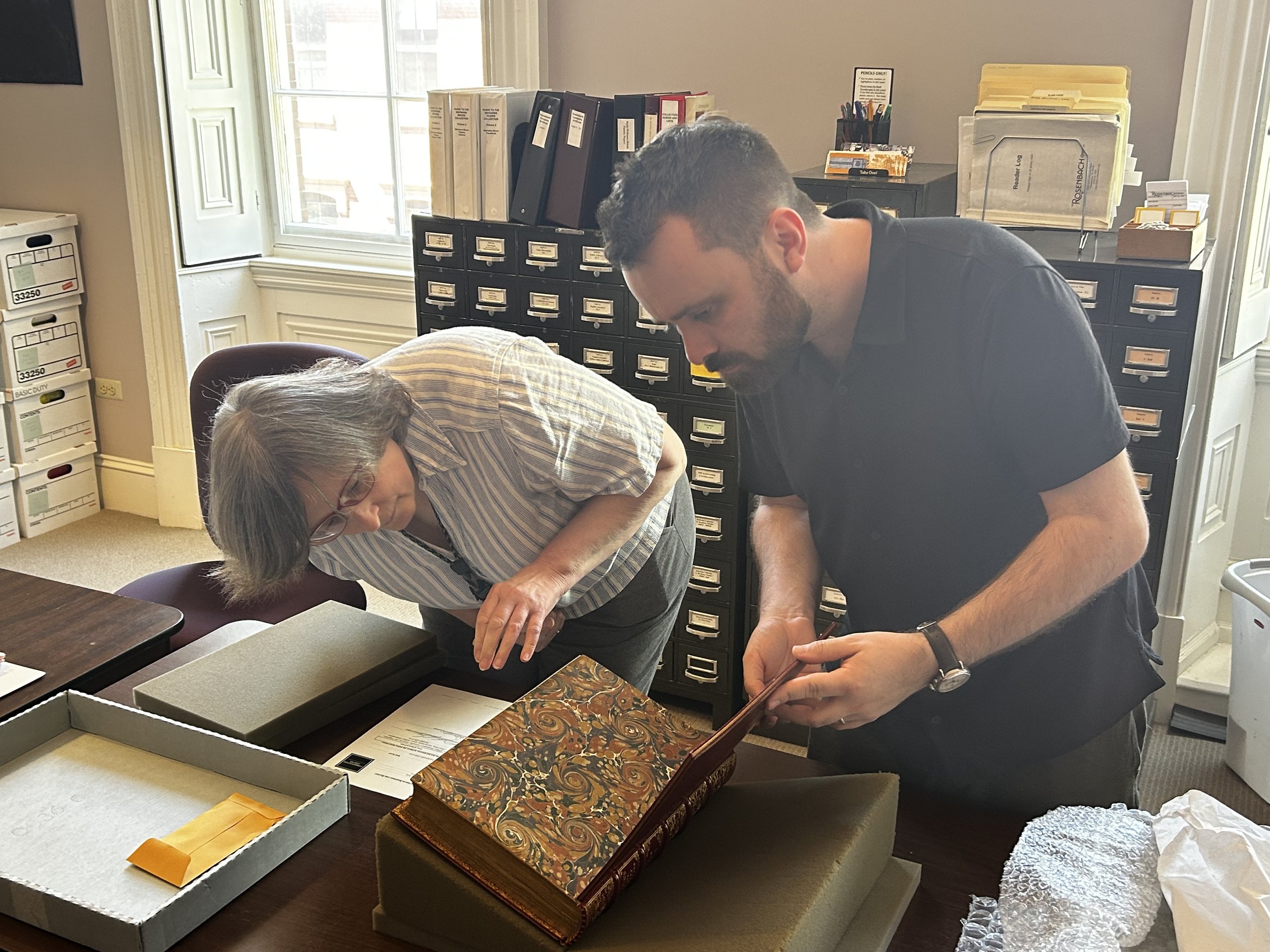 Elizabeth E. Fuller and David Rhys Owen inspect the conserved Third Folio on its return from CCAHA. Image courtesy of Kelsey Bates.
