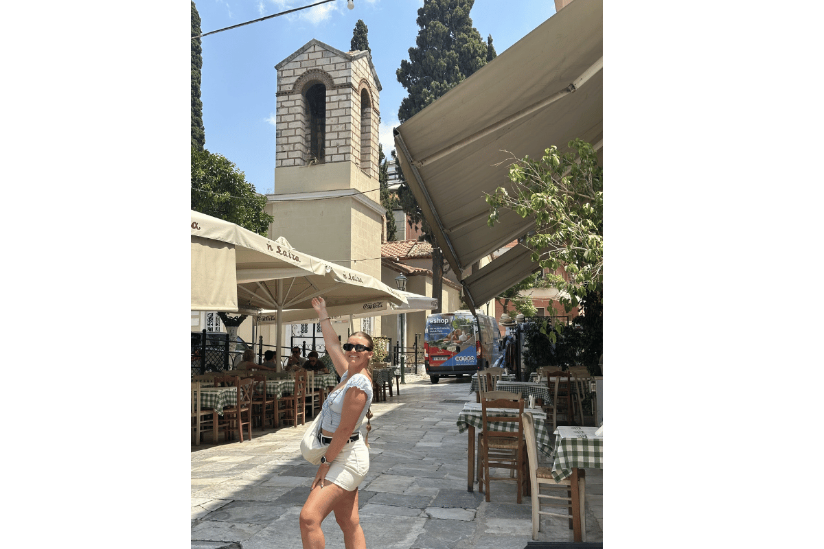Solo female traveller walking on a cobblestone street in Greece wearing practical shoes suitable for island walking.