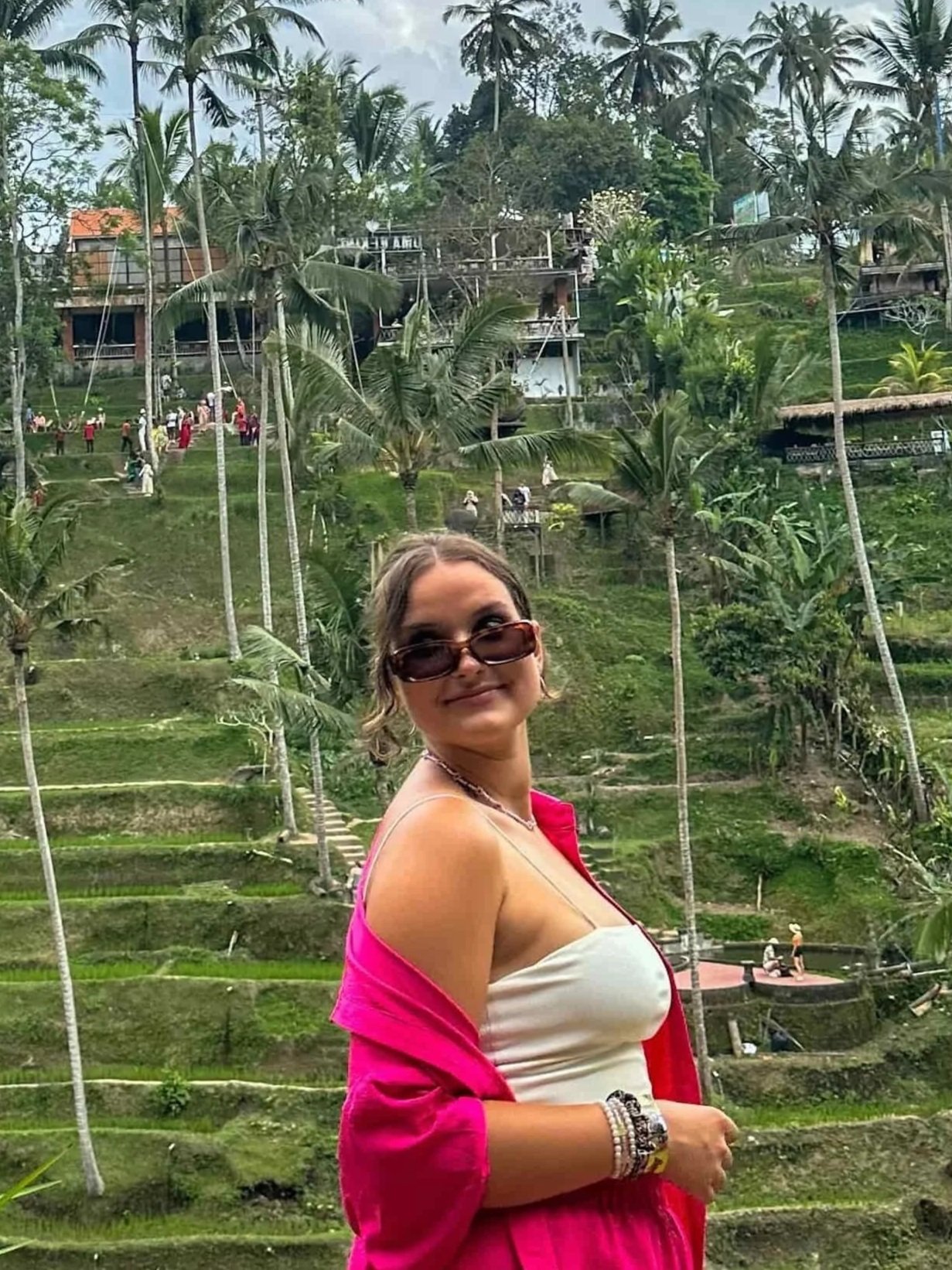 Solo female traveller looking out over Sri Lanka’s lush hills and coastline, highlighting scenic train journeys, culture, and adventure for women travelling alone.