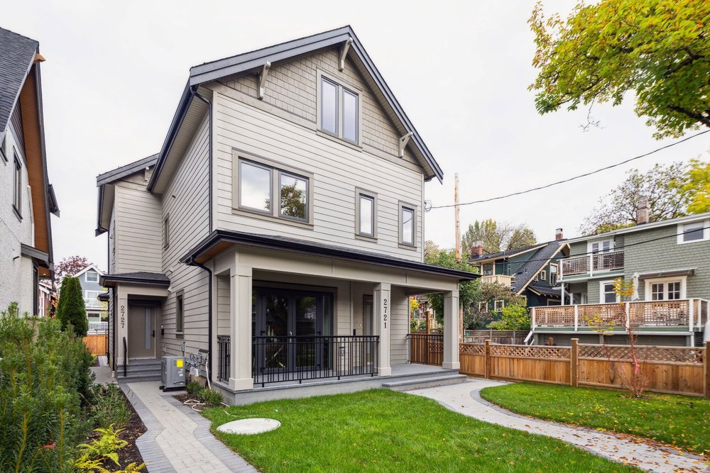 Newly built duplex-style home with a small yard