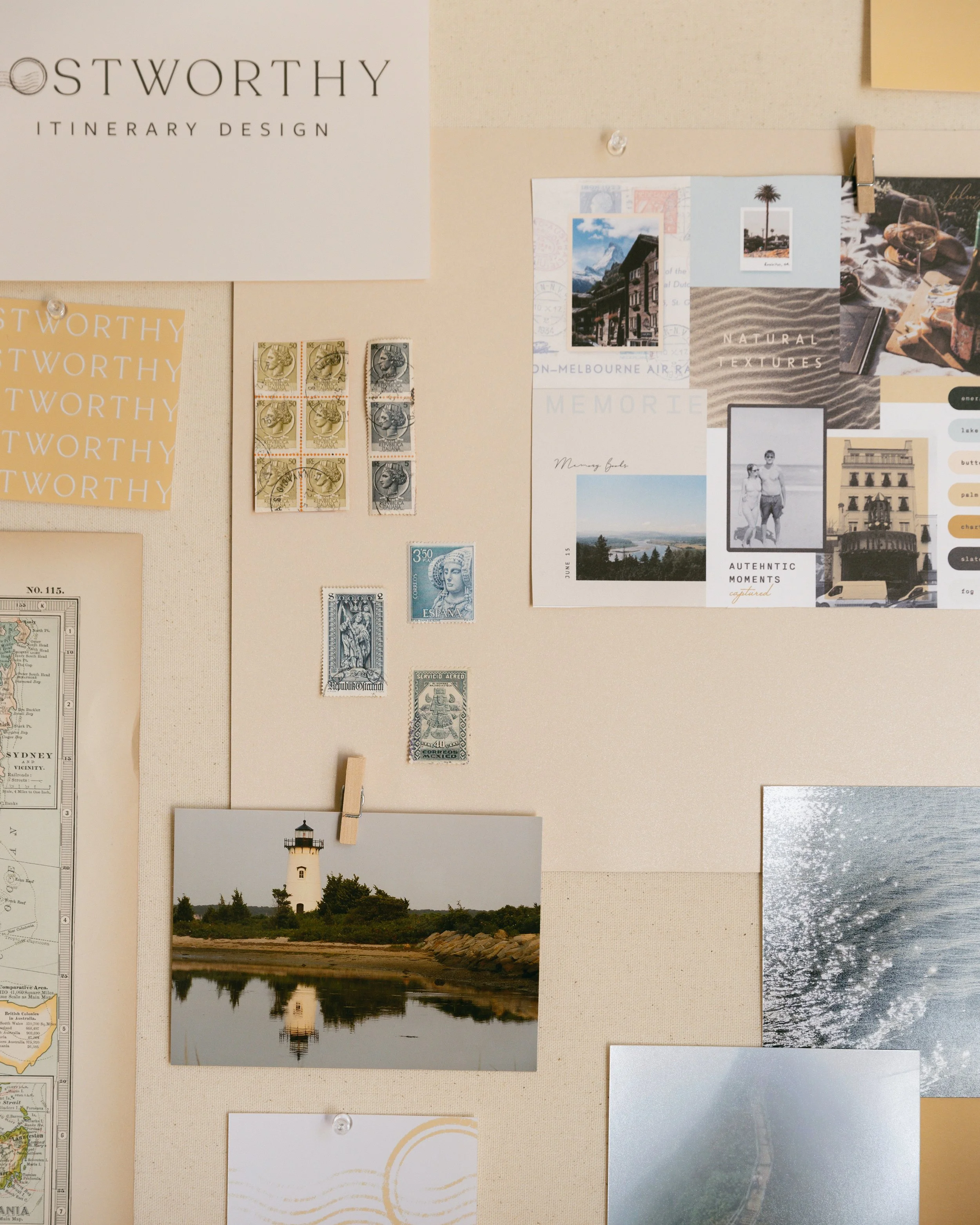 A corkboard with various postcards, photographs, stamps, and decorative papers pinned to it. The board features a lighthouse photo, a travel-themed collage, some vintage stamps, and a sign that reads 'Ostworthy Itinerary Design'.