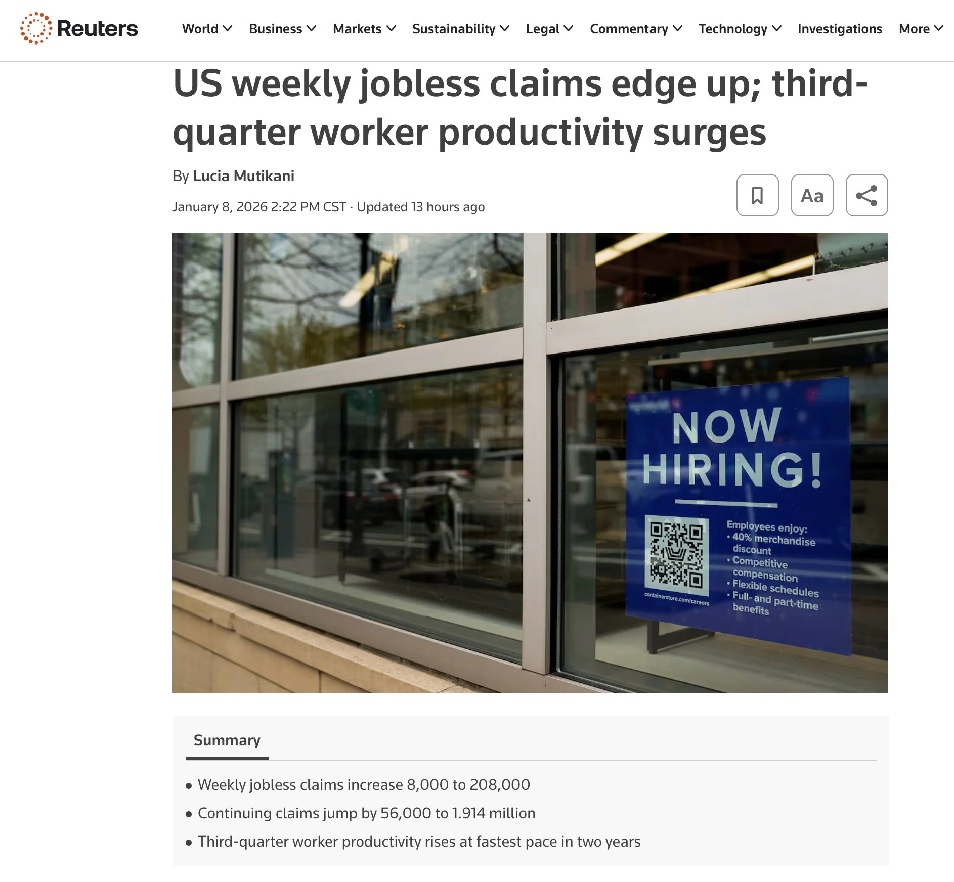 A storefront window with a blue 'Now Hiring!' sign that lists employee benefits such as merchandise discount, competitive compensation, flexible schedules, and full- and part-time benefits. The sign includes a QR code for job applications.