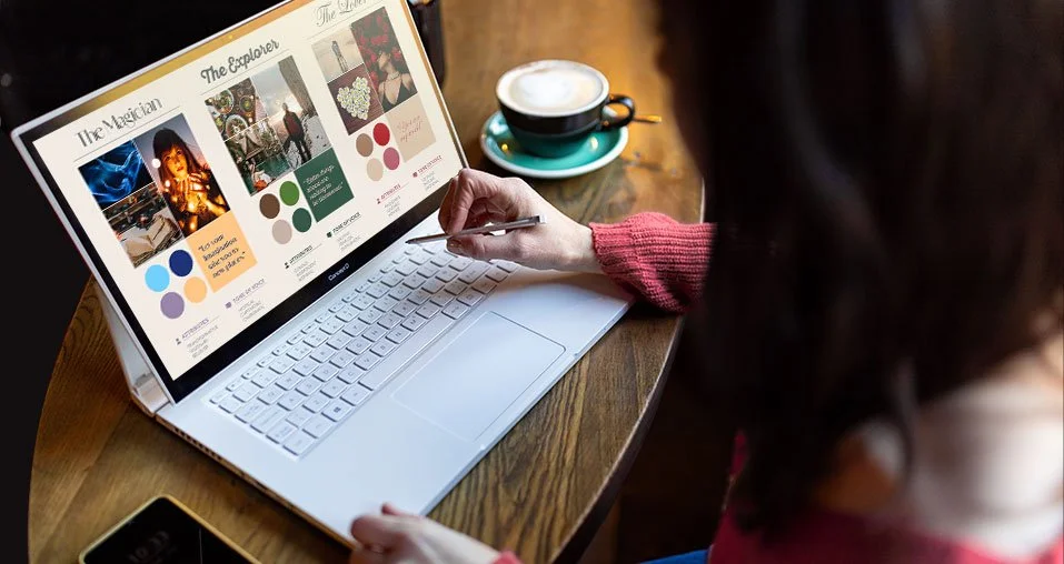 Laptop screen showing brand archetypes; Explorer, Lover and Magician