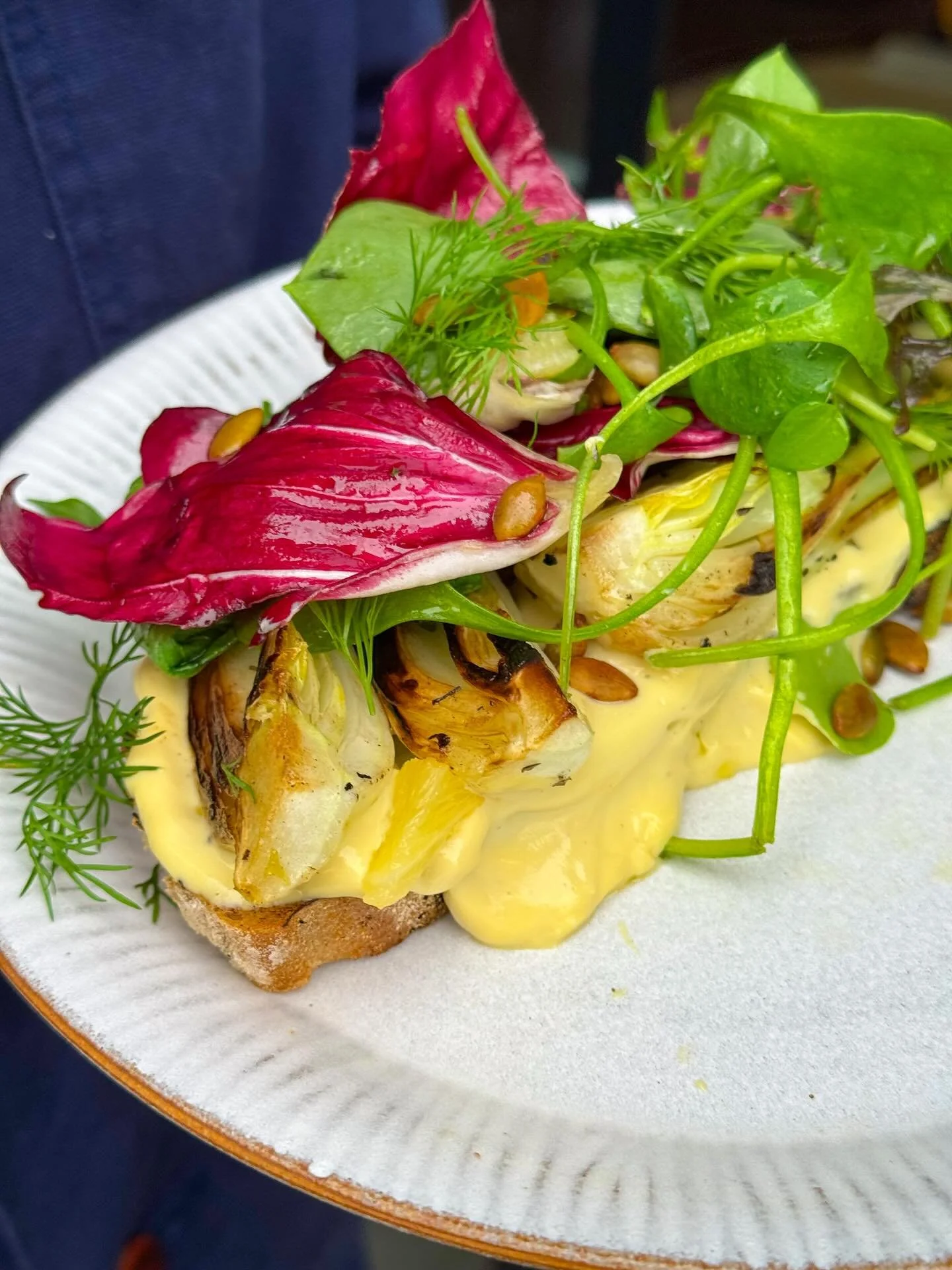 Winter Greens Toast. @e5bakehouse Stockholm bread loaded with in house aioli, seared greens, seasonal leaves, citrus, pumpkin seeds and fresh herbs 🌱

With sneaky protein in the aioli and plenty of fibre in the greens and grains, this one feels indu