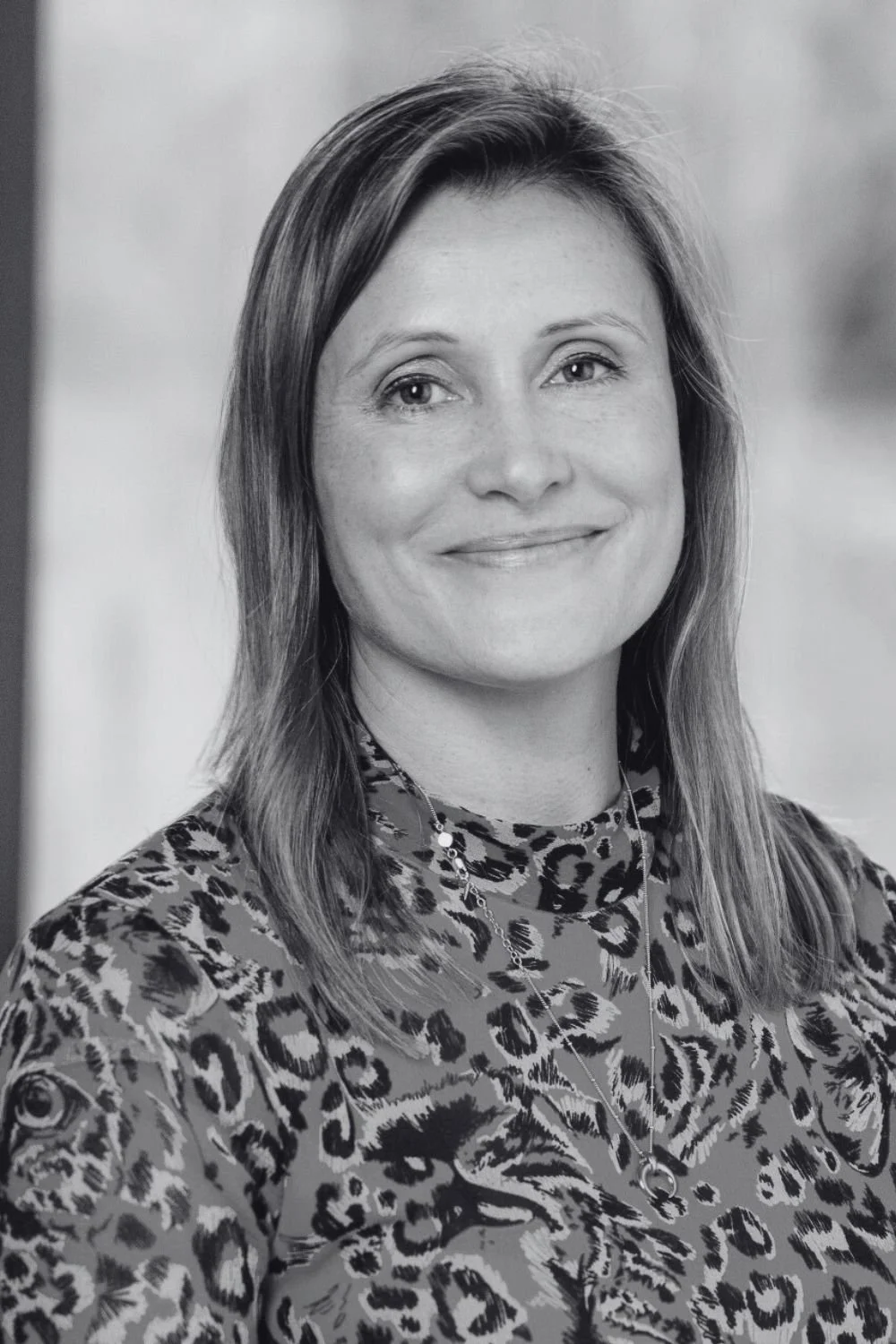 Smiling woman wearing a blouse, with mid length hair called Bonnie, Chief Financial Officer at CFT