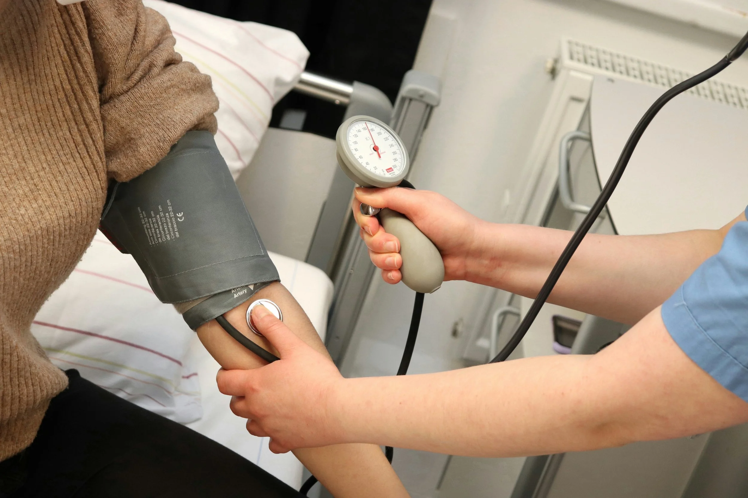 A nurse taking a patient's blood pressure