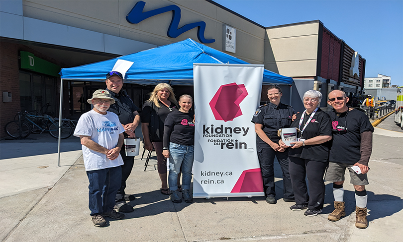 Group of people in front of kidney poster
