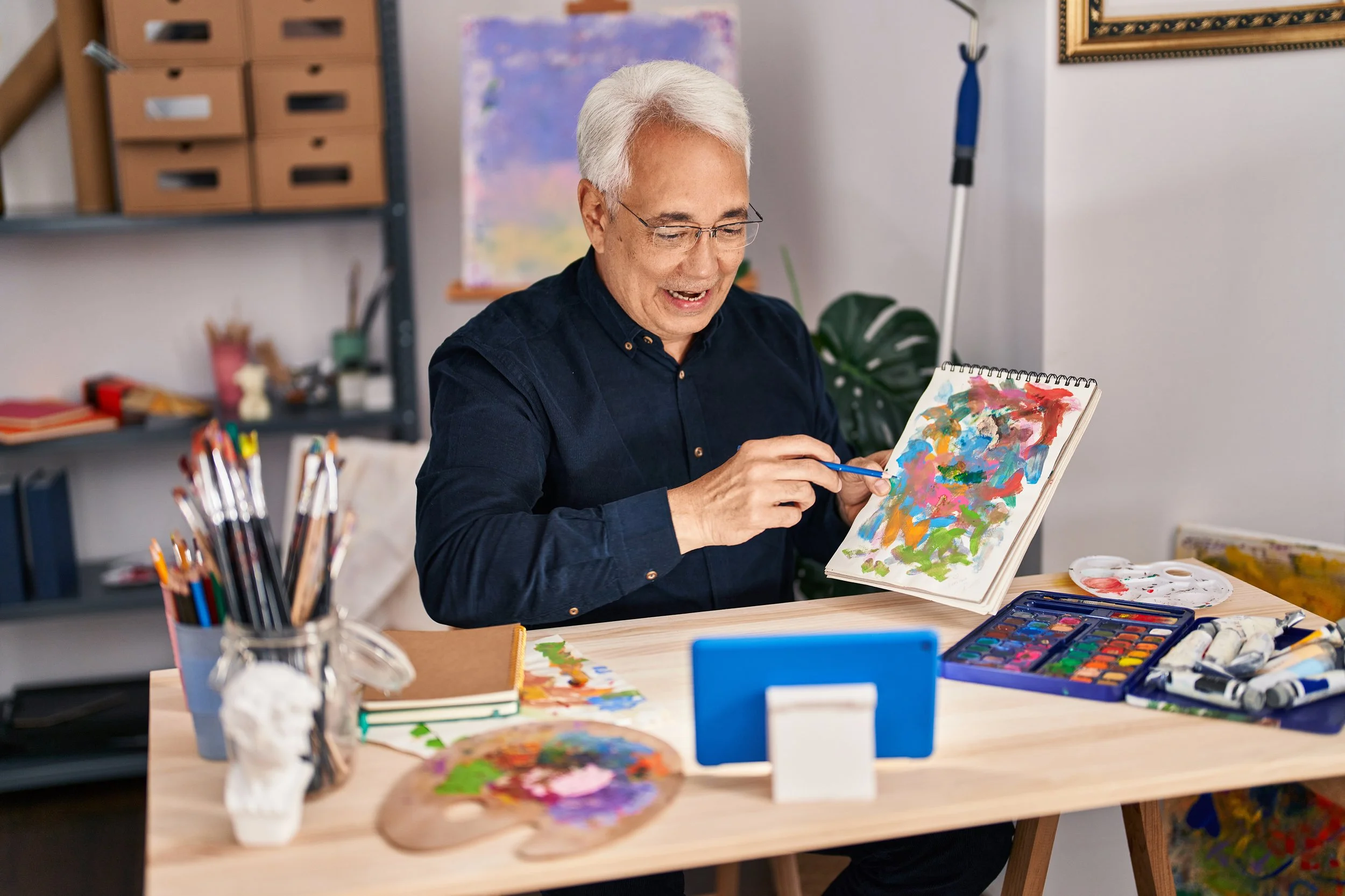 Man showing his painting