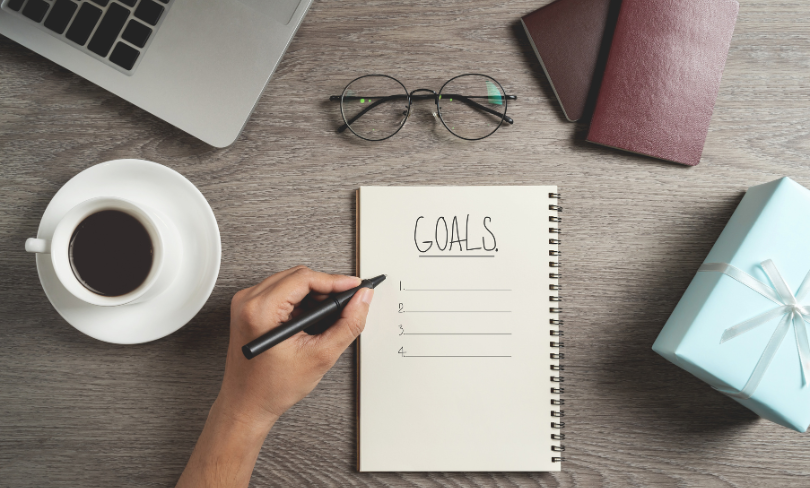 hand jotting on a  planner