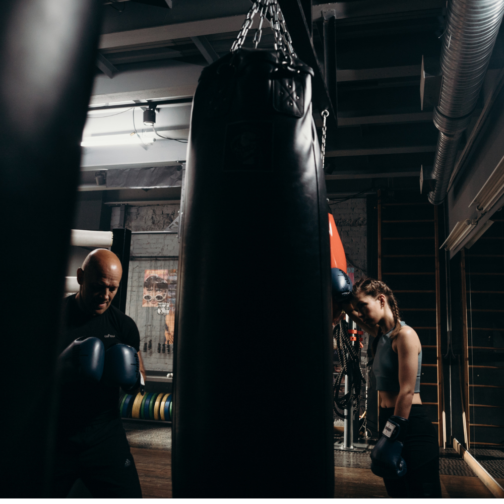Boxing coach training a beginner in Sterling, VA.png