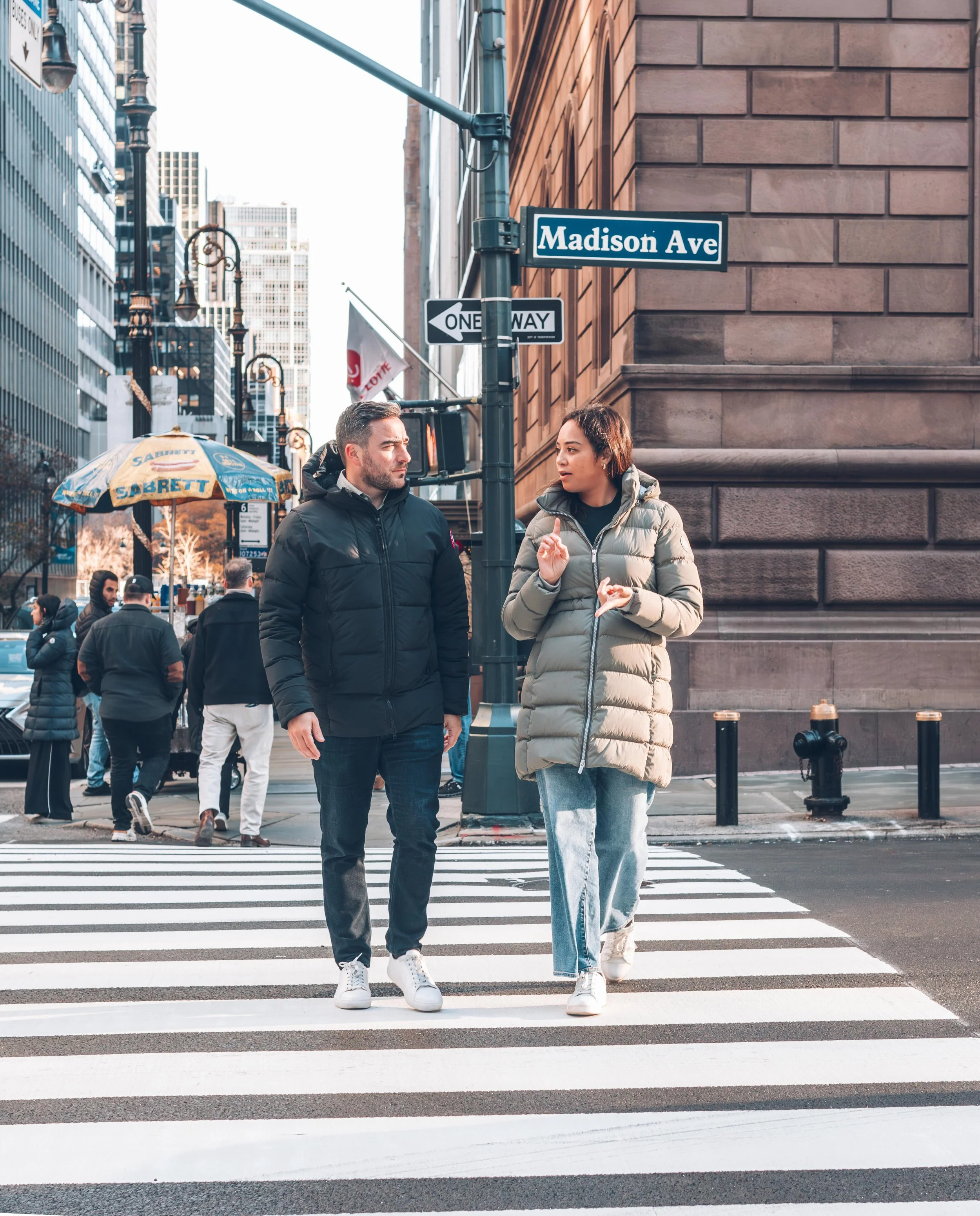 Conor and Madilyn O’Leary, founders of O’Leary Group, walking along Madison Avenue in New York City.