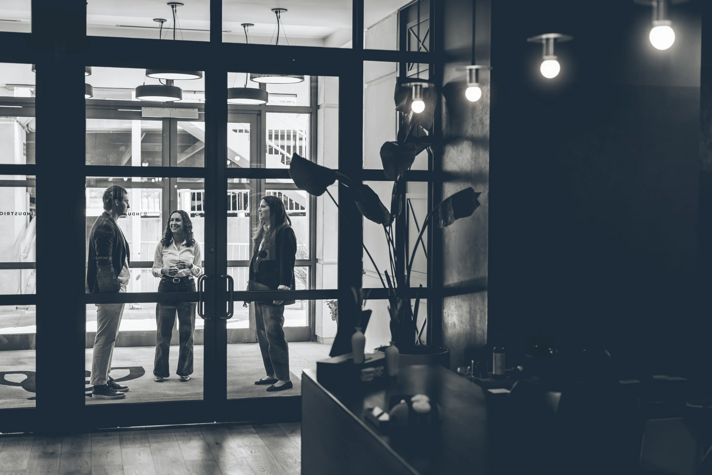 Three O’Leary Group team members waiting in a lobby before a site walkthrough.