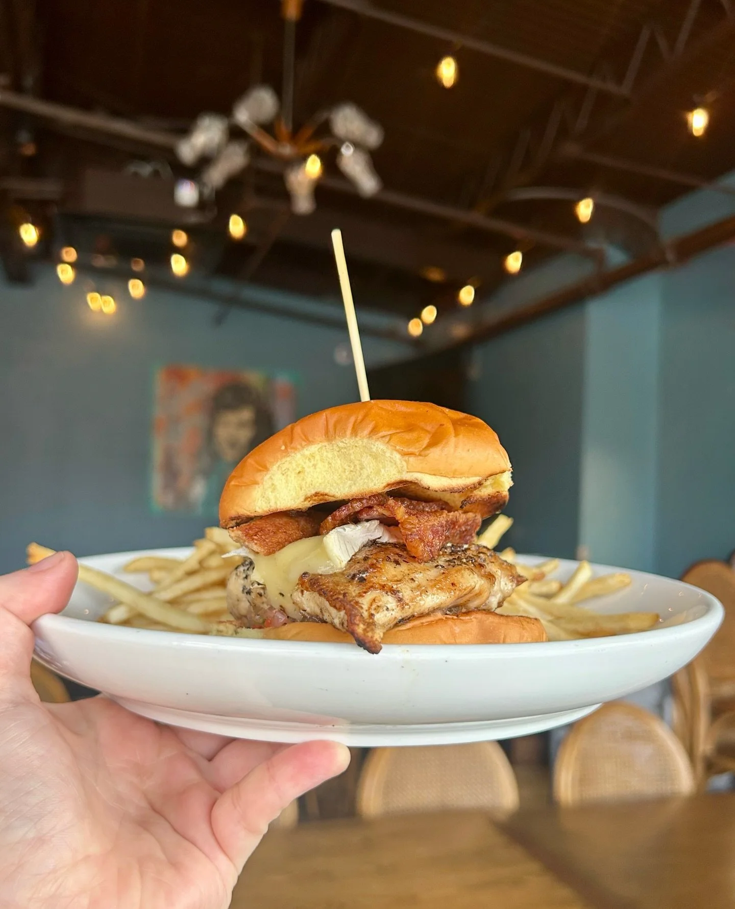 There is nothing cozier than a delicious Hickory Grilled Chicken sandwich on a cold day. ⁠
⁠
Featuring hickory wood-fired grilled chicken with bacon, brie, burnt onion jam, pickled serrano, all on a Martin&rsquo;s Potato Roll, and served with fries.⁠