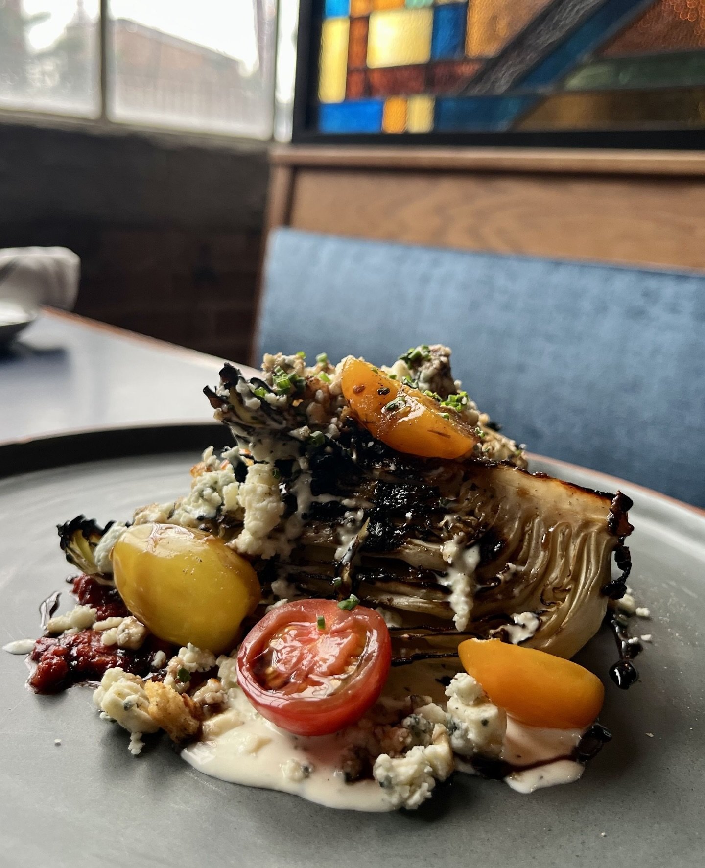 Tonight&rsquo;s appetizer special is the &ldquo;Wedge&rdquo; Salad created by Chef de Cuisine @detzelspretzels 
⁠
Grilled dew drop cabbage, warm &lsquo;Nduja sausage, house made bleu cheese dressing, bleu cheese crumbles, heirloom cherry tomatoes, le