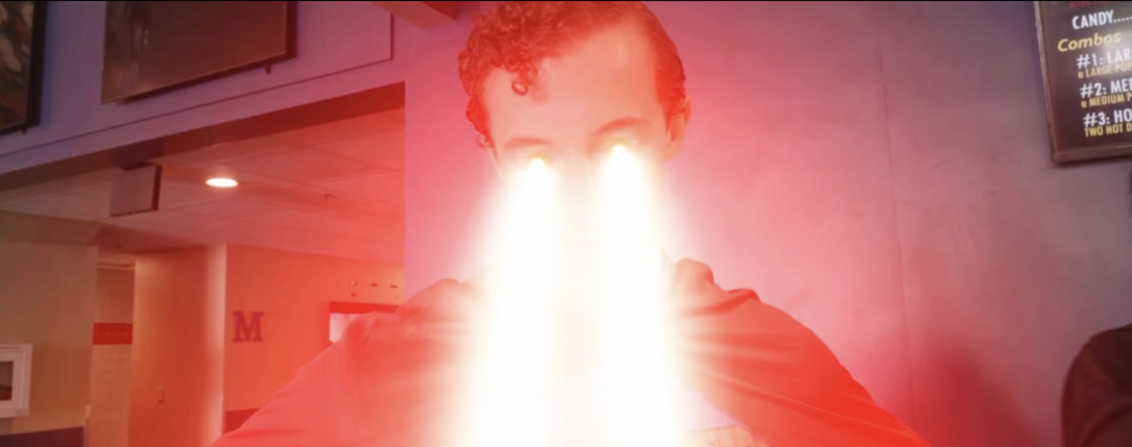 Person in a red hoodie has a fire jetting out of their mouth, creating a bright flame with a glowing effect.