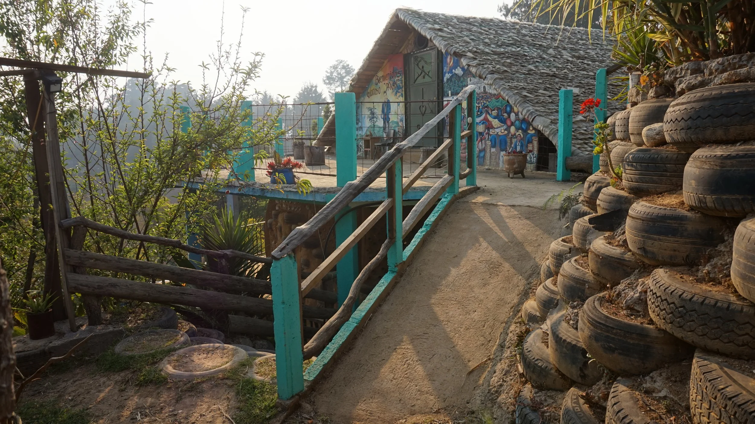 Tire retention walls and plastic roof shingles are just some of the reused materials you'll see here