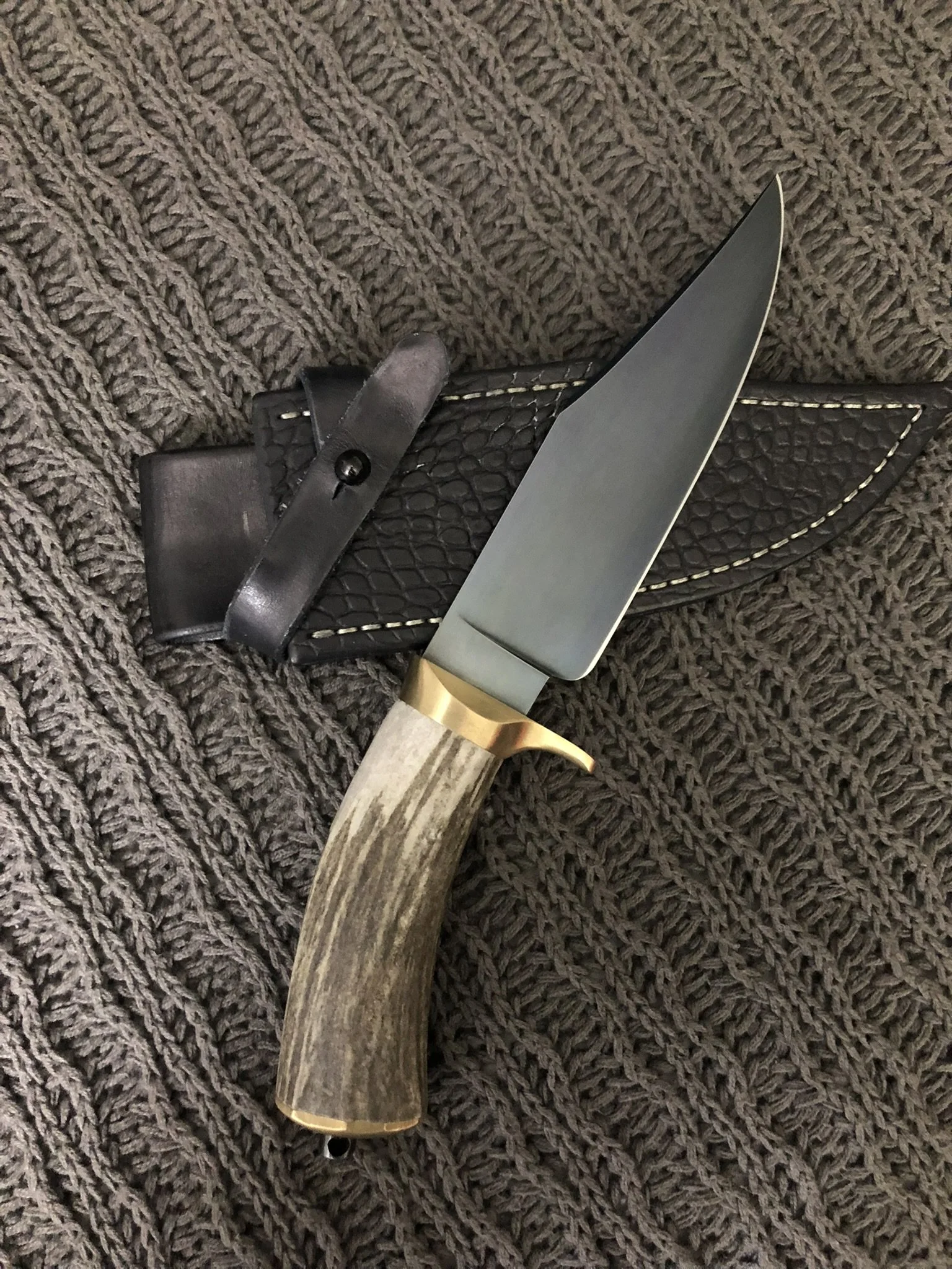 Commissioned Clip Point Bowie Resting on Custom Sheath