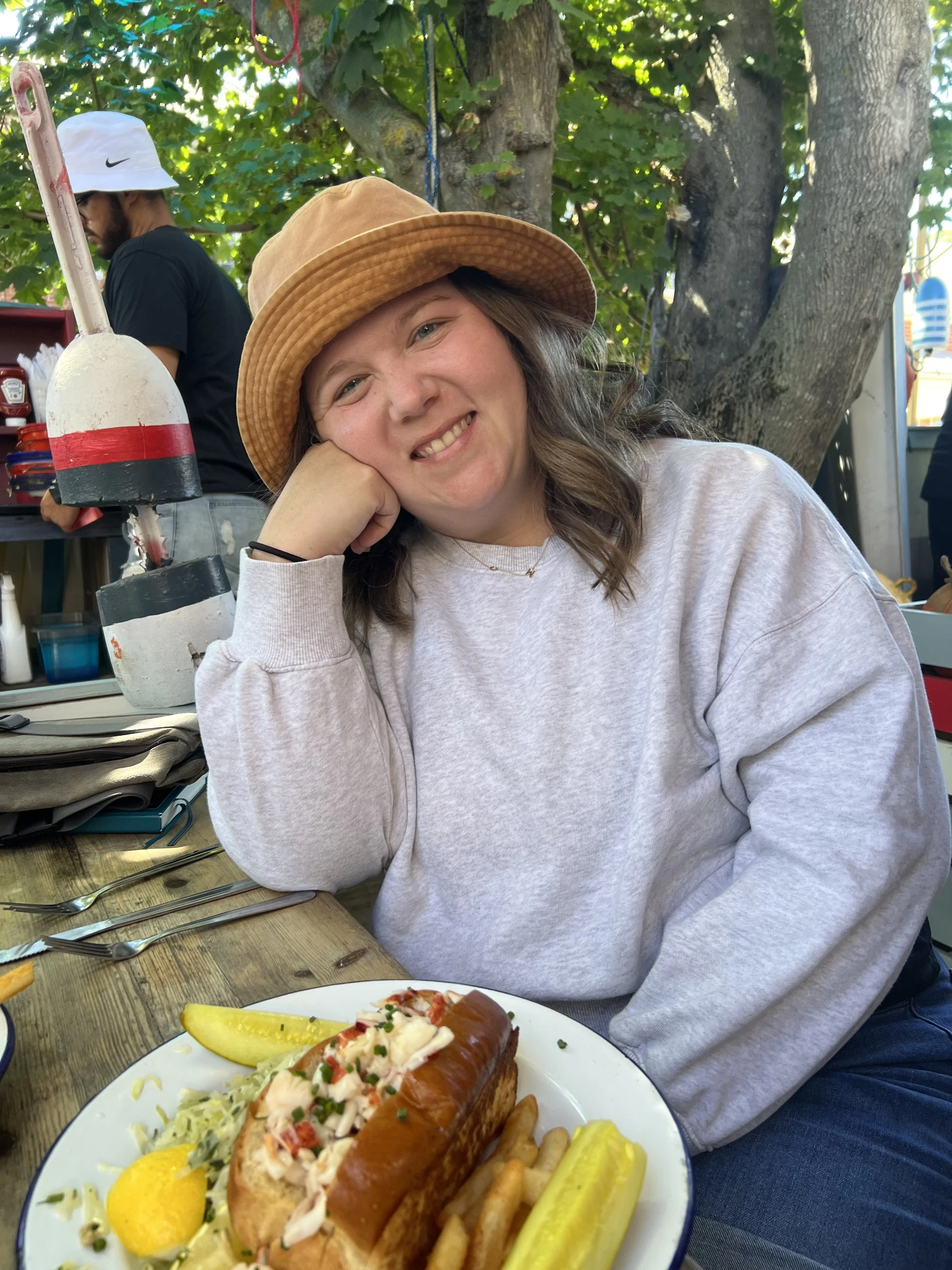 courtney smiling with a lobster roll that she enjoyed while her kids ate french fries