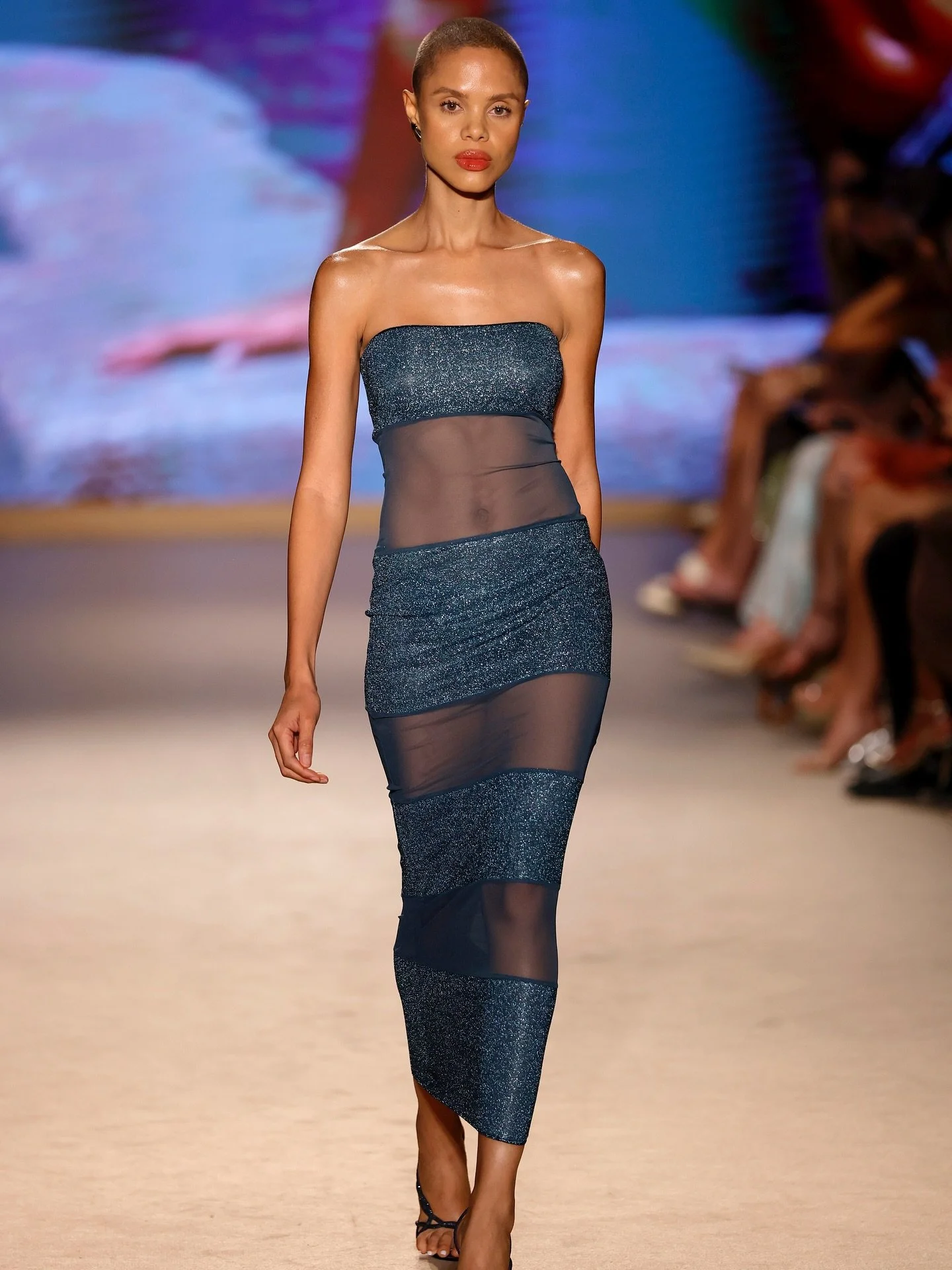 @greyquelliz graces the PARAISO runway for @osereeswimwear in their sheer paneled dress, shimmering with deep ocean hues