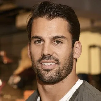 Portrait of a man with a beard and short hair indoors